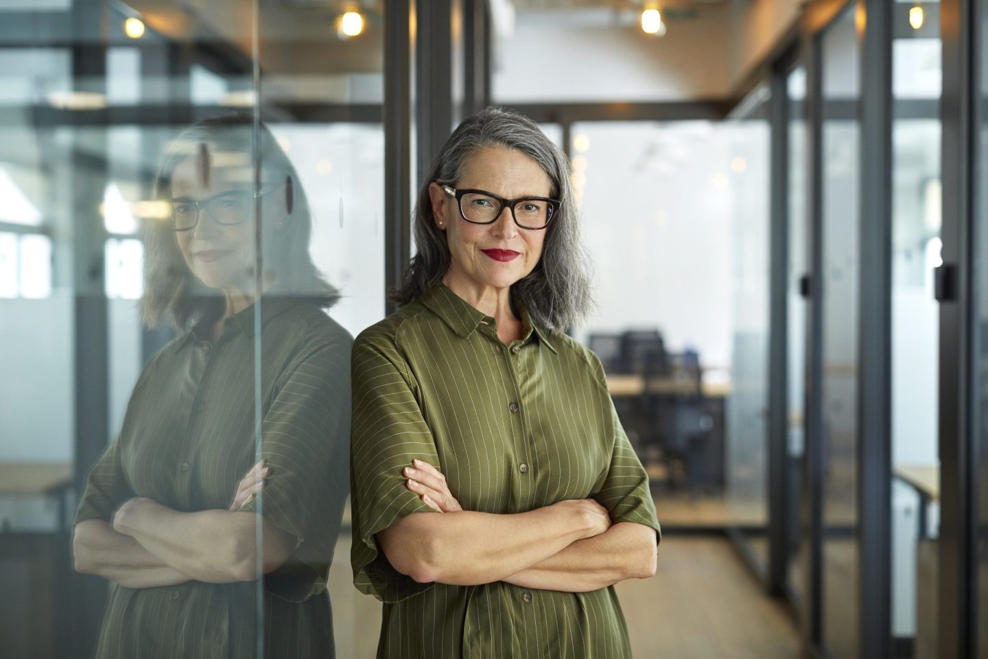 Confident mature businesswoman with arms crossed