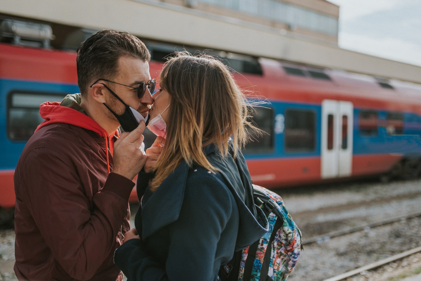 Couple in masks kissing