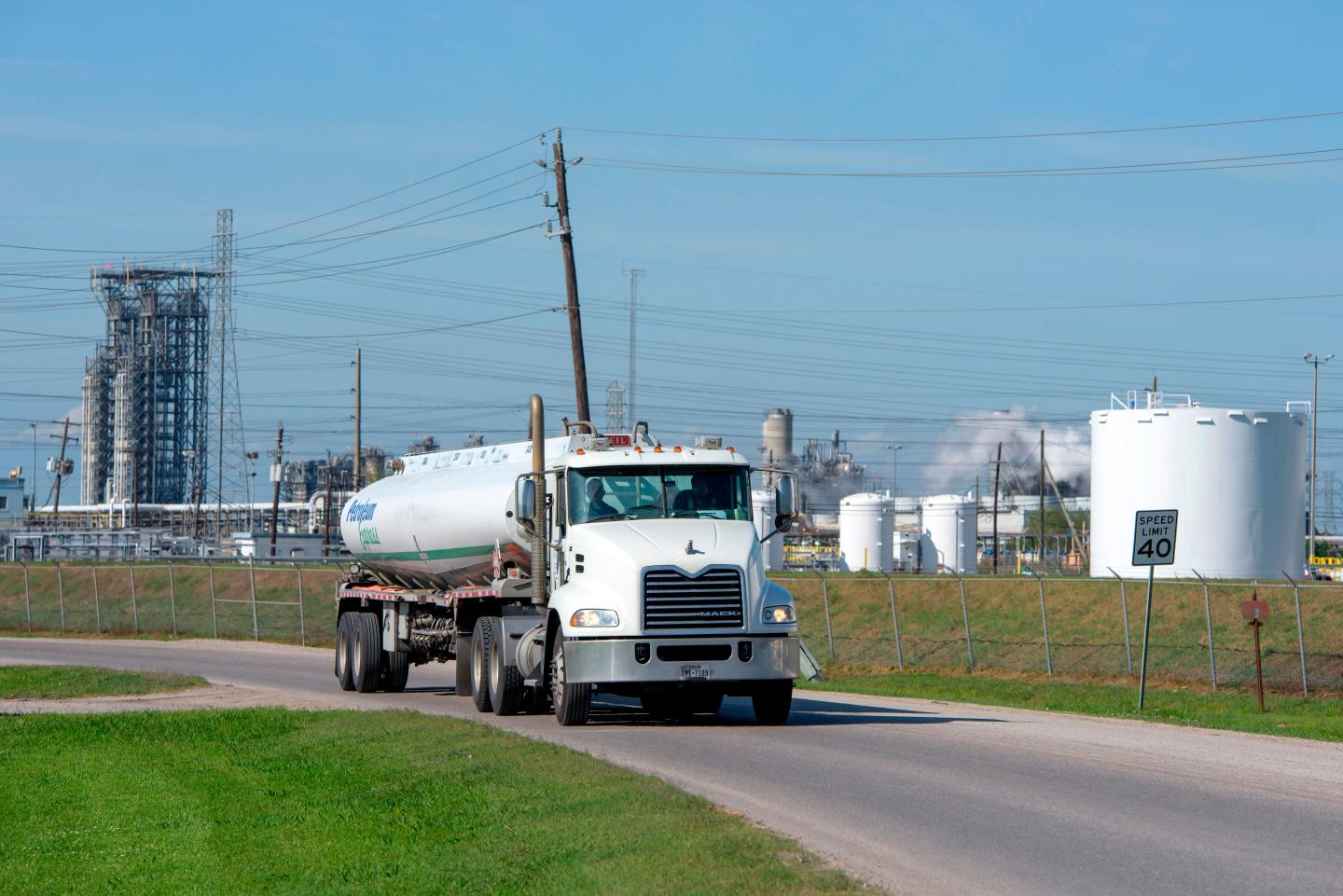 A truck drives past an oil storage facility next to the Phillip 66 oil refinery on April 21, 2020