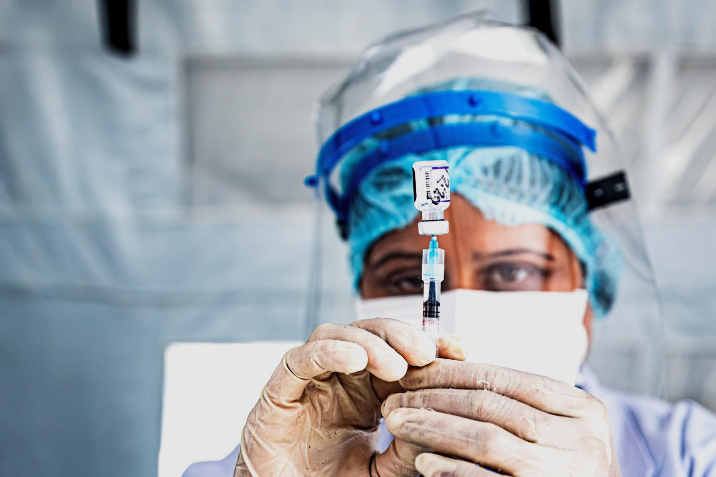 A health worker prepares the Pfizer vaccine