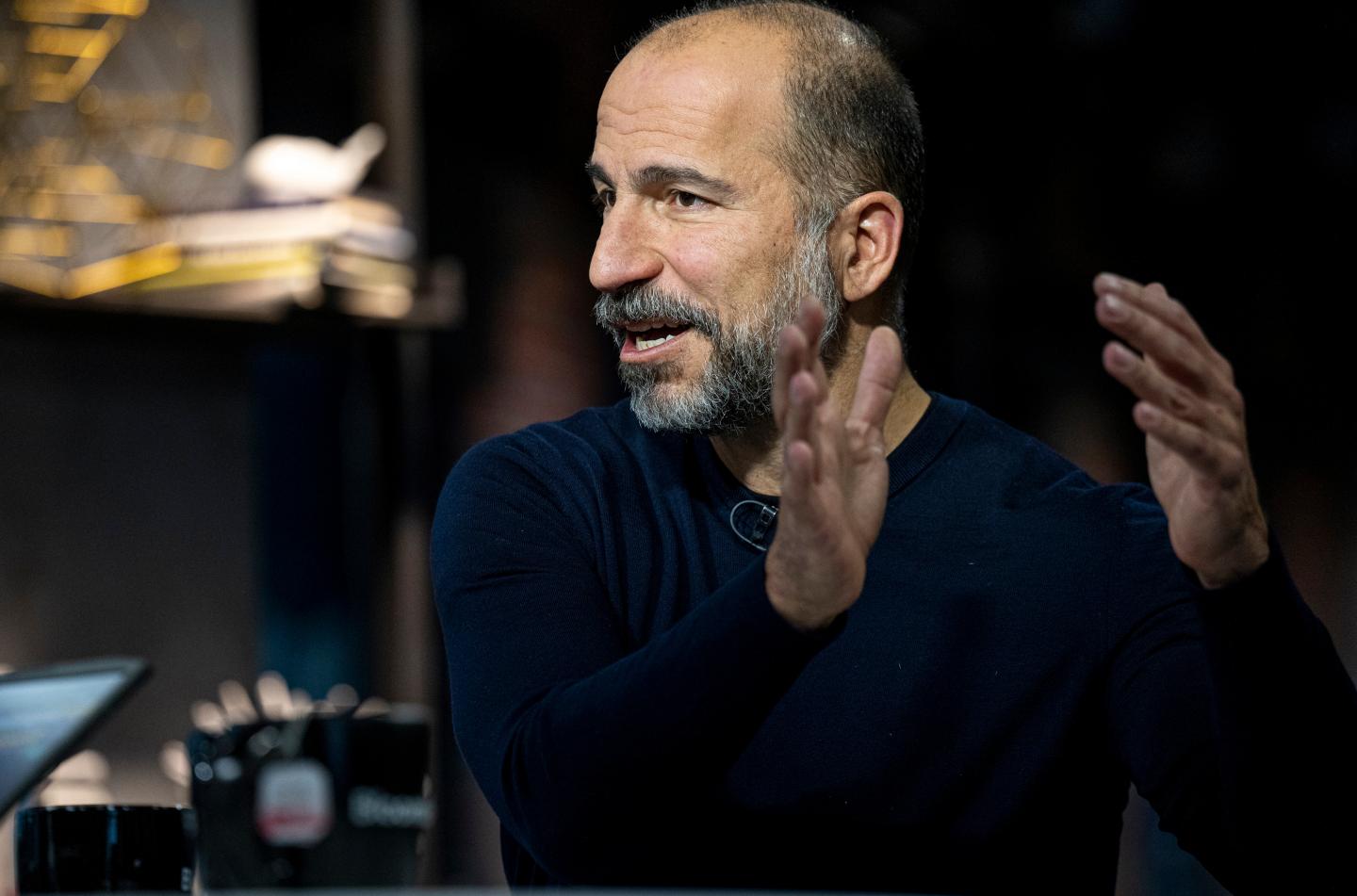 The photograph shows a still from a Bloomberg interview with Dara Khosrowshahi, Uber's CEO.