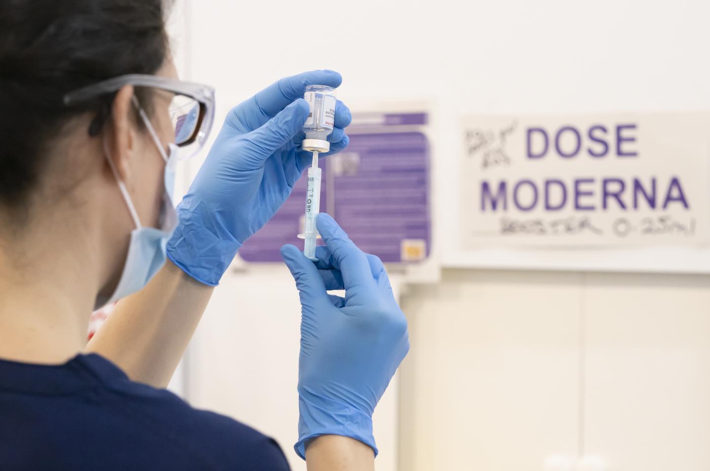 A Moderna booster coronavirus vaccine dose is drawn into a syringe at a Covid vaccination centre at Elland Road in Leeds, UK.