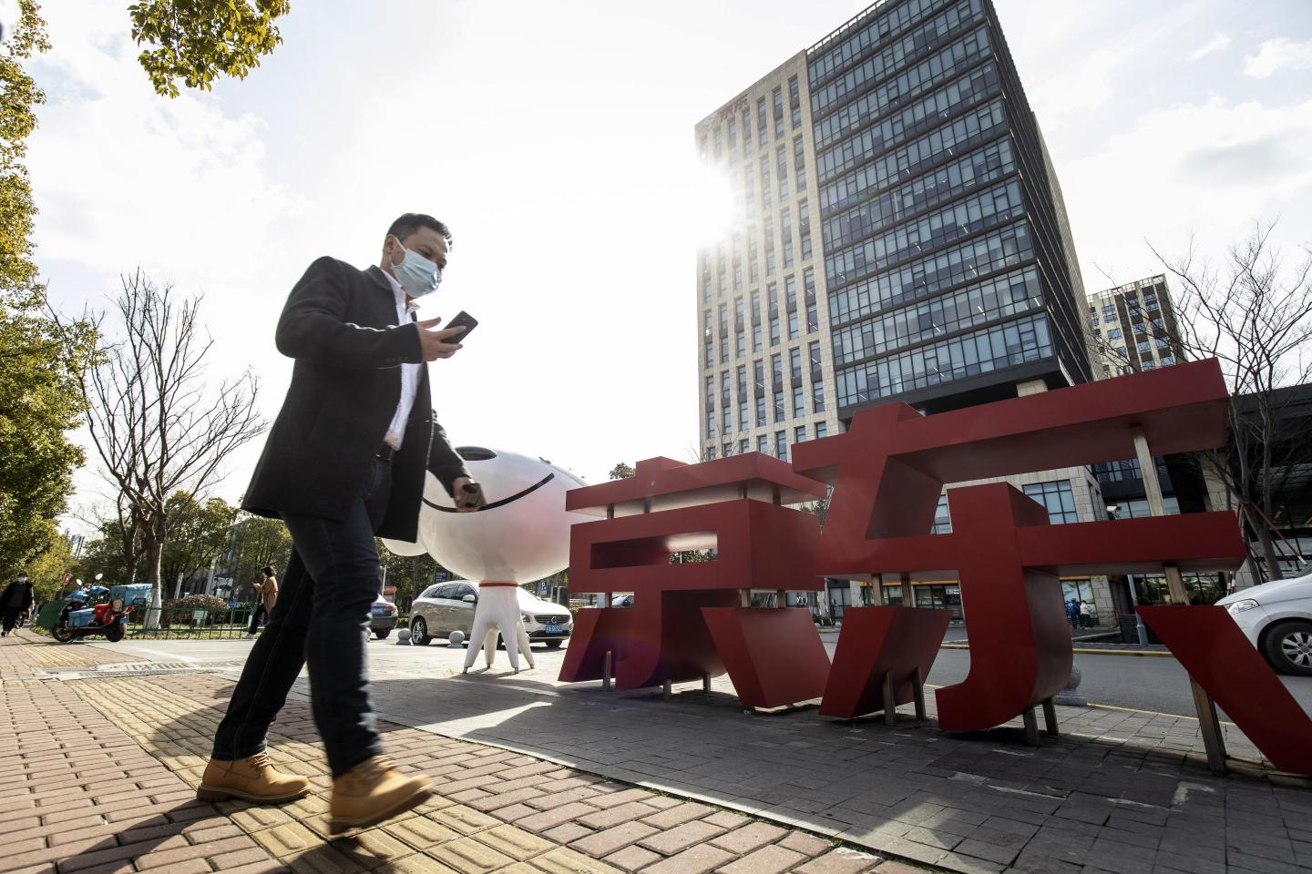 A man walks past JD.com's office in Shanghai