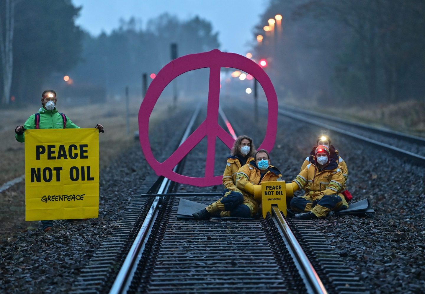 15 March 2022, Brandenburg, Schwedt: Early this morning, activists from Greenpeace block a rail track leading to the oil refinery of PCK-Raffinerie GmbH. With this action, Greenpeace protests against fossil imports from Russia and the indirect financing of the war in Ukraine.