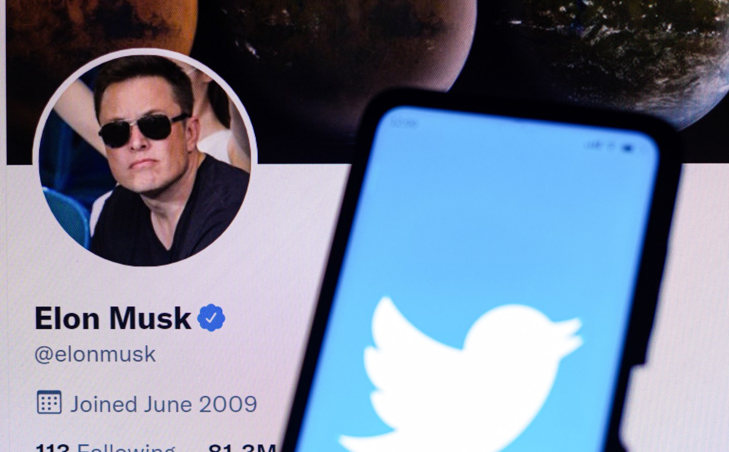 In this photo illustration, the Twitter logo is displayed on a smartphone with Elon Musk's official Twitter profile. The billionaire Elon Musk bought 9% of Twitter, an investment of USD 3 billion.