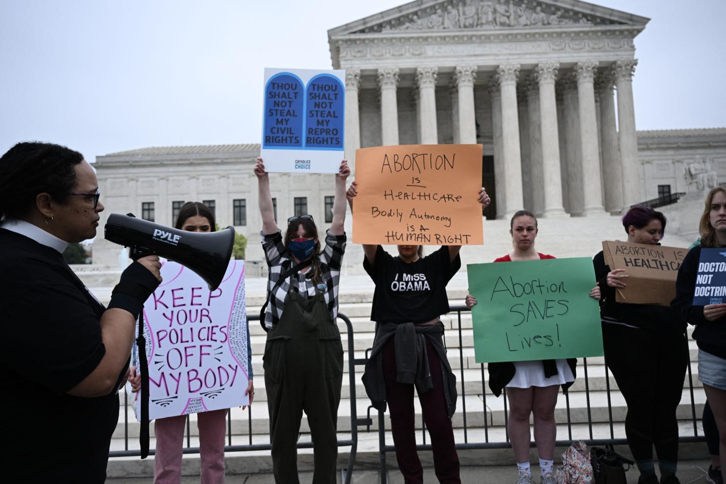 Pro-choice demonstrators hold signs in front of the US Supreme Court.