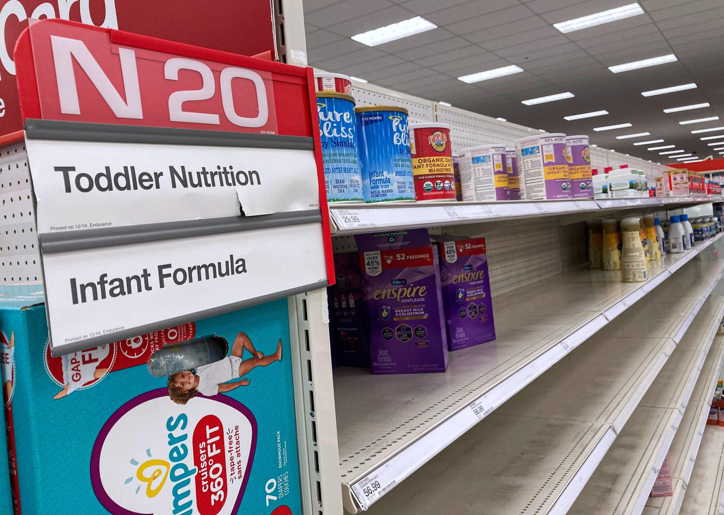 A nearly empty infant formula shelf in a supermarket