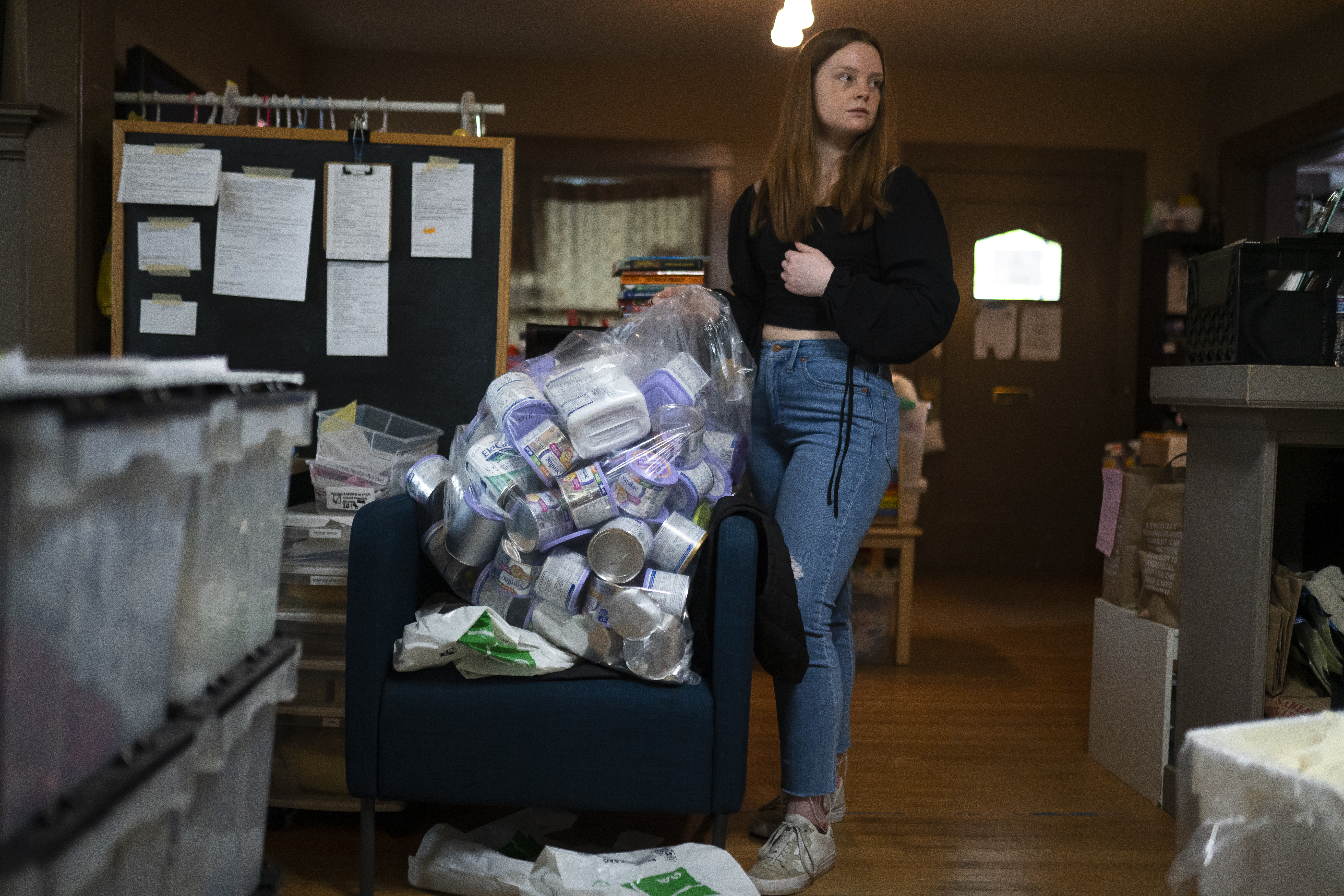 Katie Wussler, a program coordinator at Mother & Child Education Center, disposes of recalled Similac baby formula, which the company would not replace or reimburse because the donated supplies did not come with a receipt, on May 12 in Portland, Oregon.