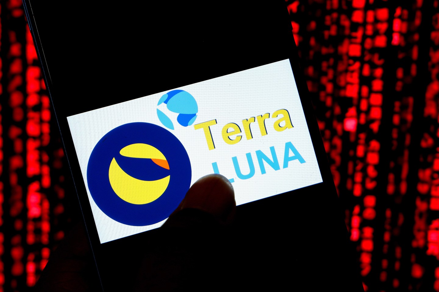 A photo illustration of a Terra Luna cryptocurrency logo