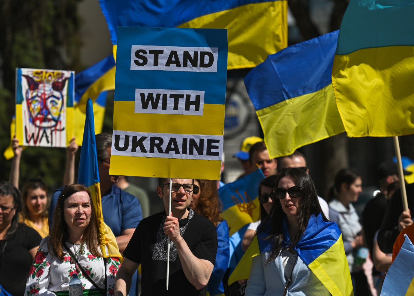 A protester holds a placard with words 'Stand With Ukraine'. Members of the local Ukrainian diaspora, peace activists and supporters took part in 'Alberta Stands with Ukraine!' - a protest organized by the Edmonton Branch of the Ukrainian Canadian Congress in front of Edmonton City Hall.