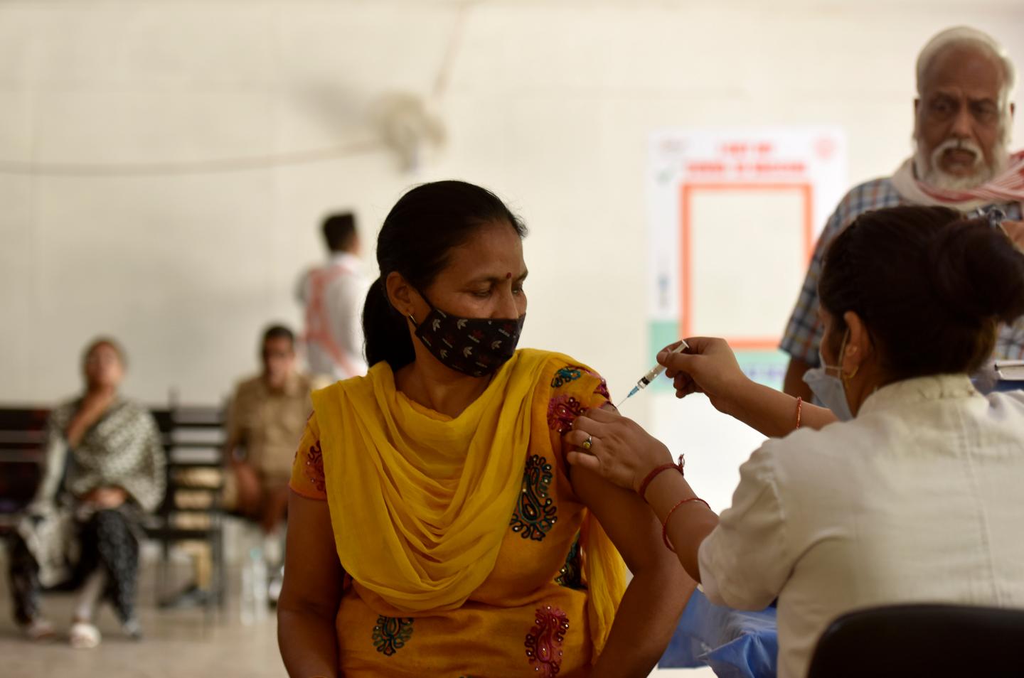Getting vaccinated after infection can ease long COVID symptoms, large new study says