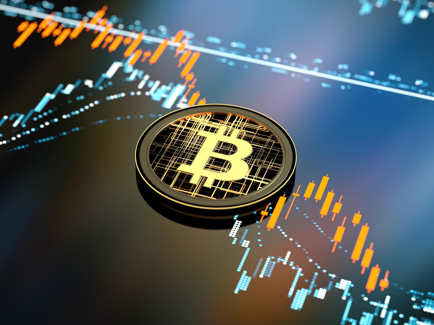 A graphic shows a Bitcoin against a chart tracking price declines.
