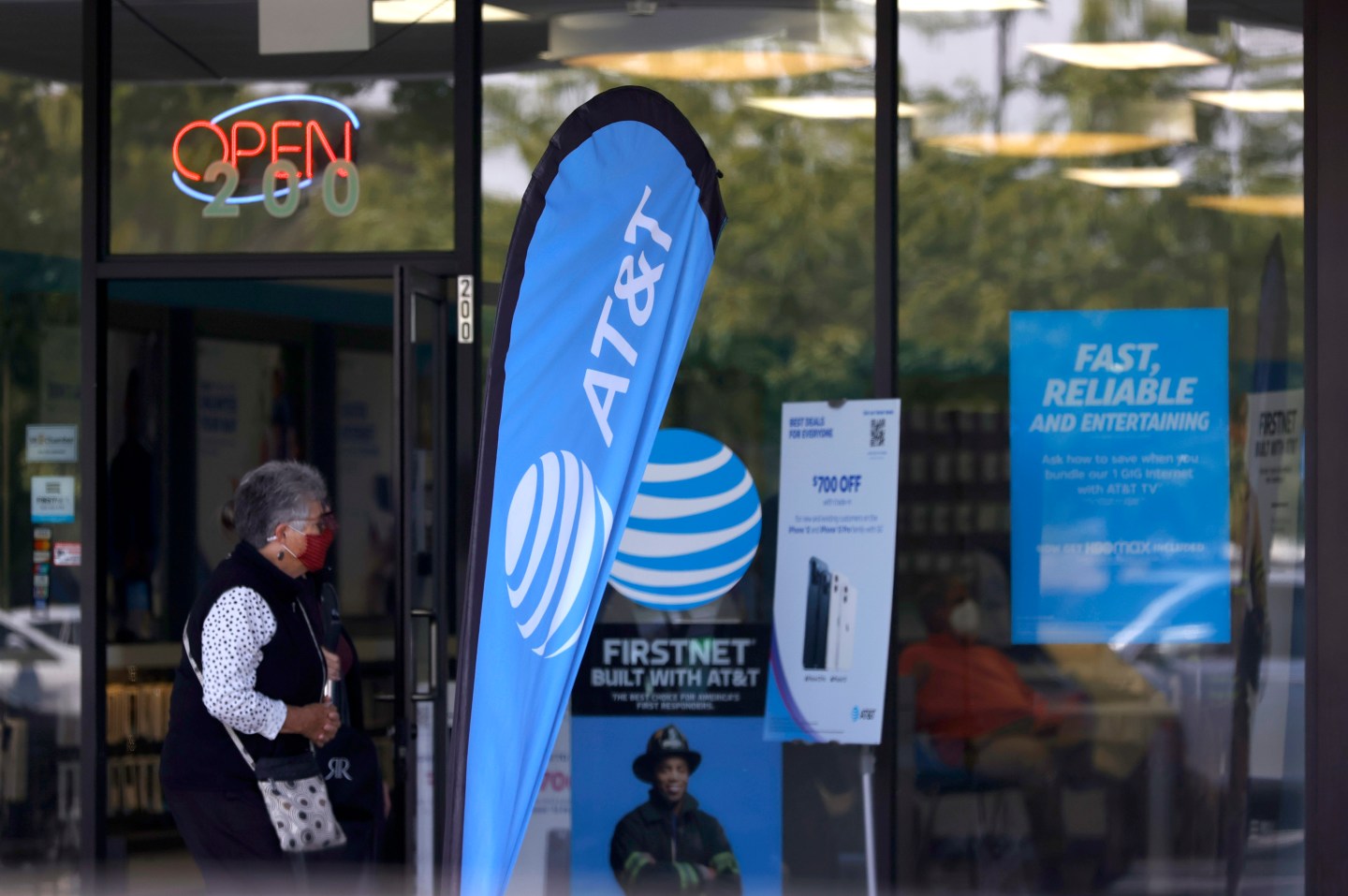 Woman walks by an AT&T store