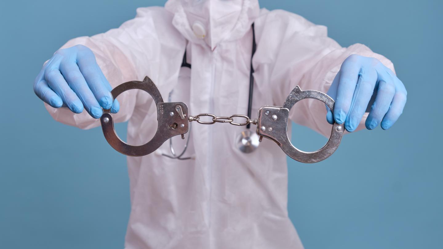 Doctor with handcuffs.