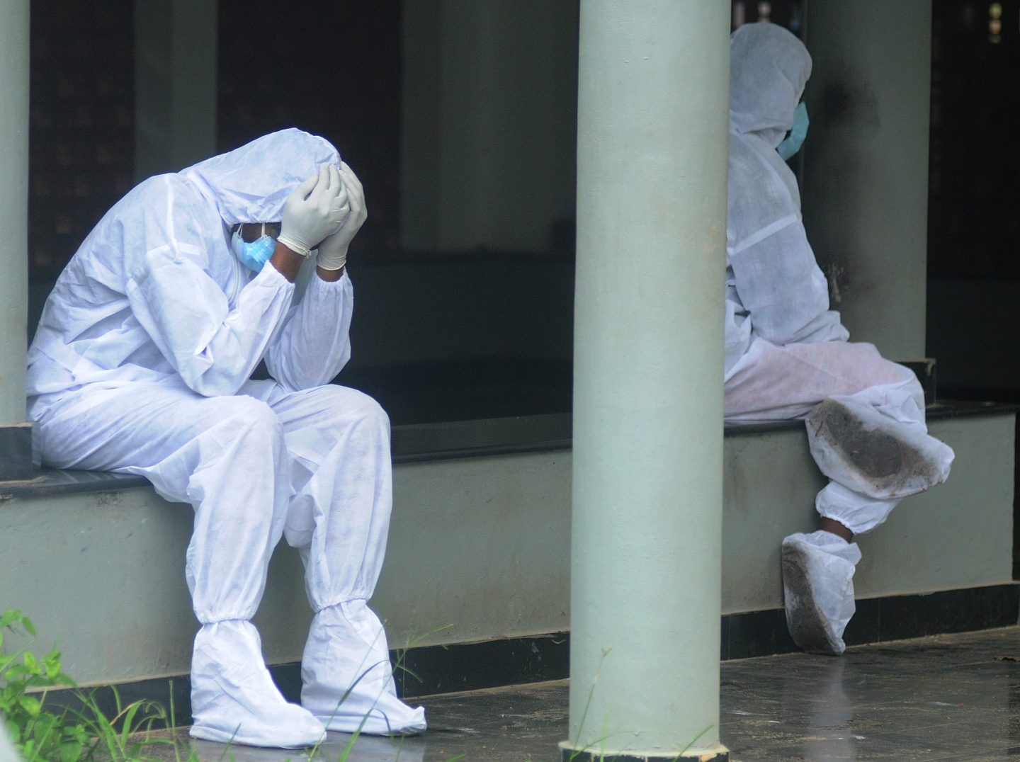 COVID-19 India worker head in hands