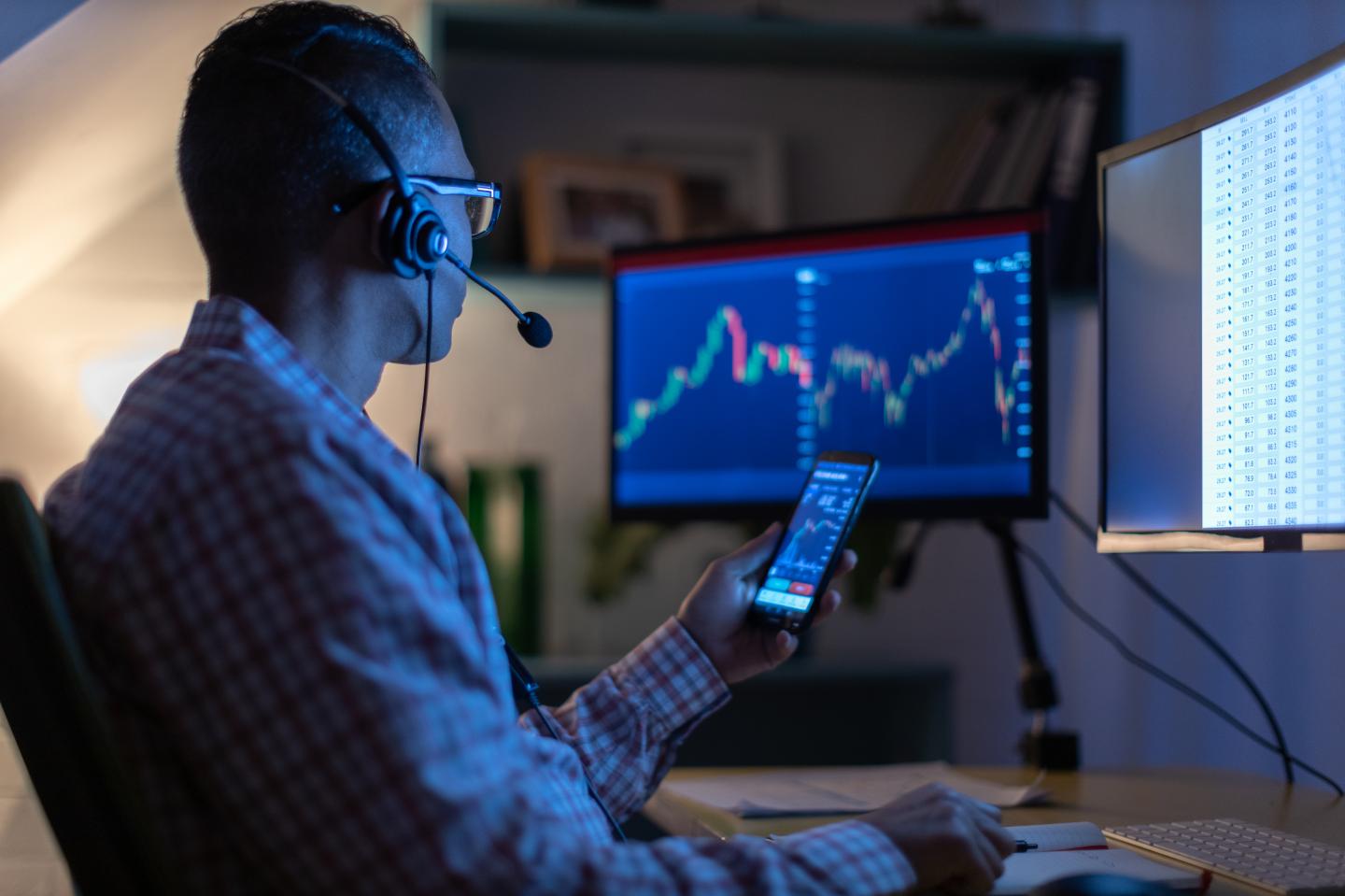 man looking at currency on terminal