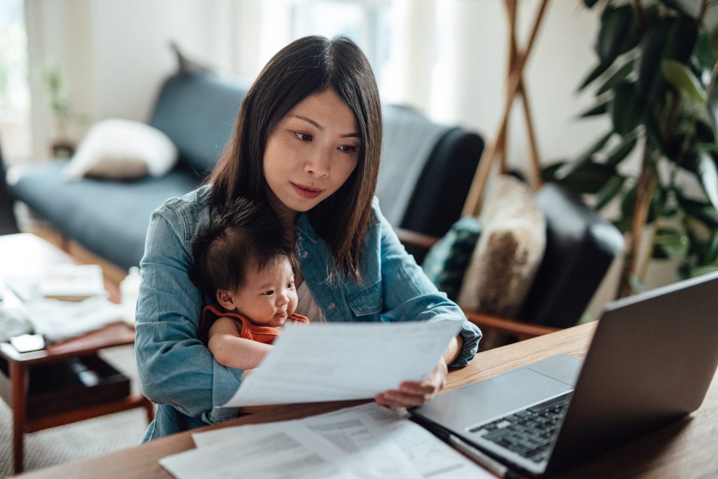Mother working from home with baby daughter