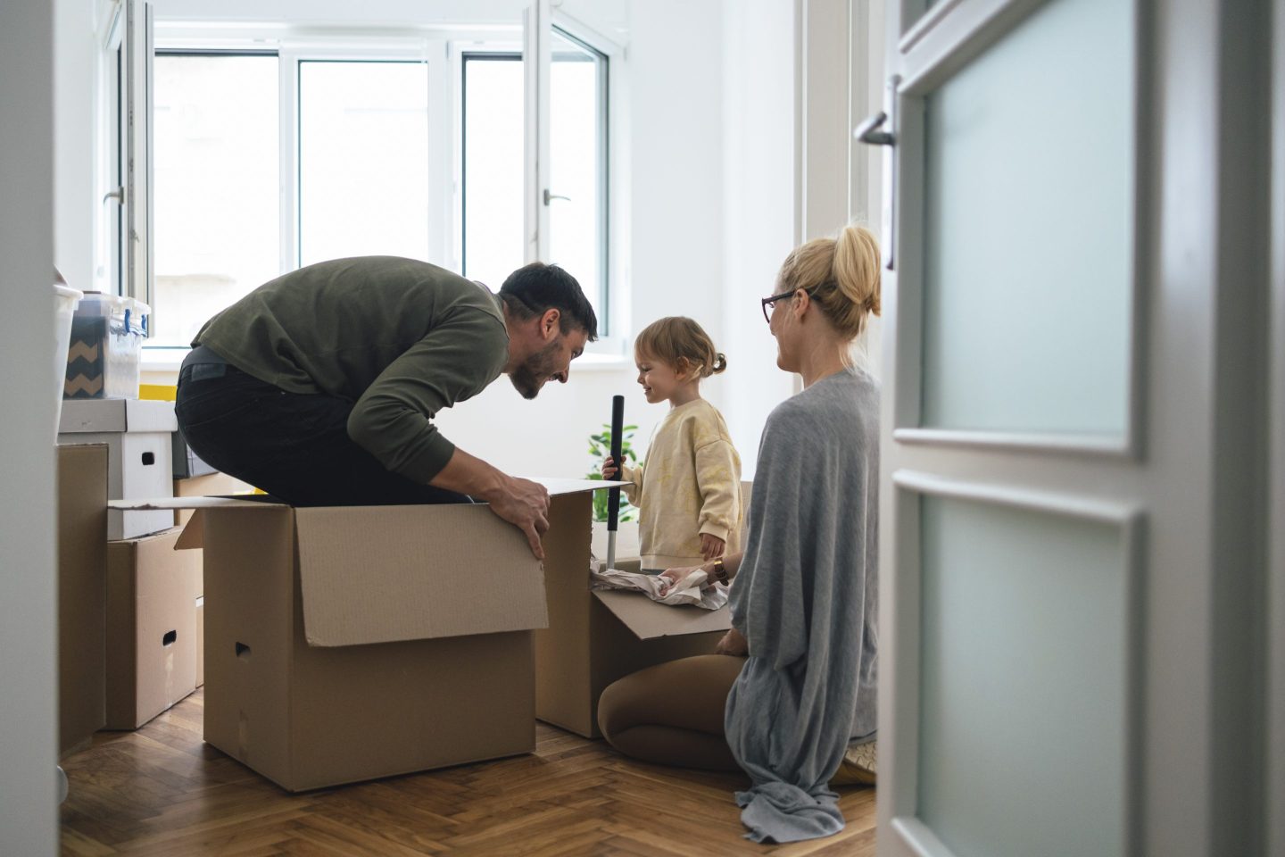 Family of Three Playing a Game While Moving