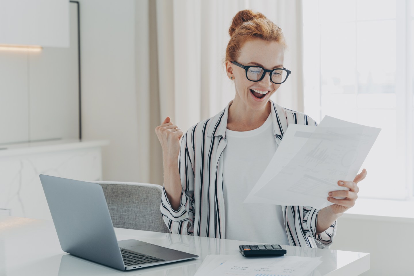 A photo of a woman looking at a piece of paper
