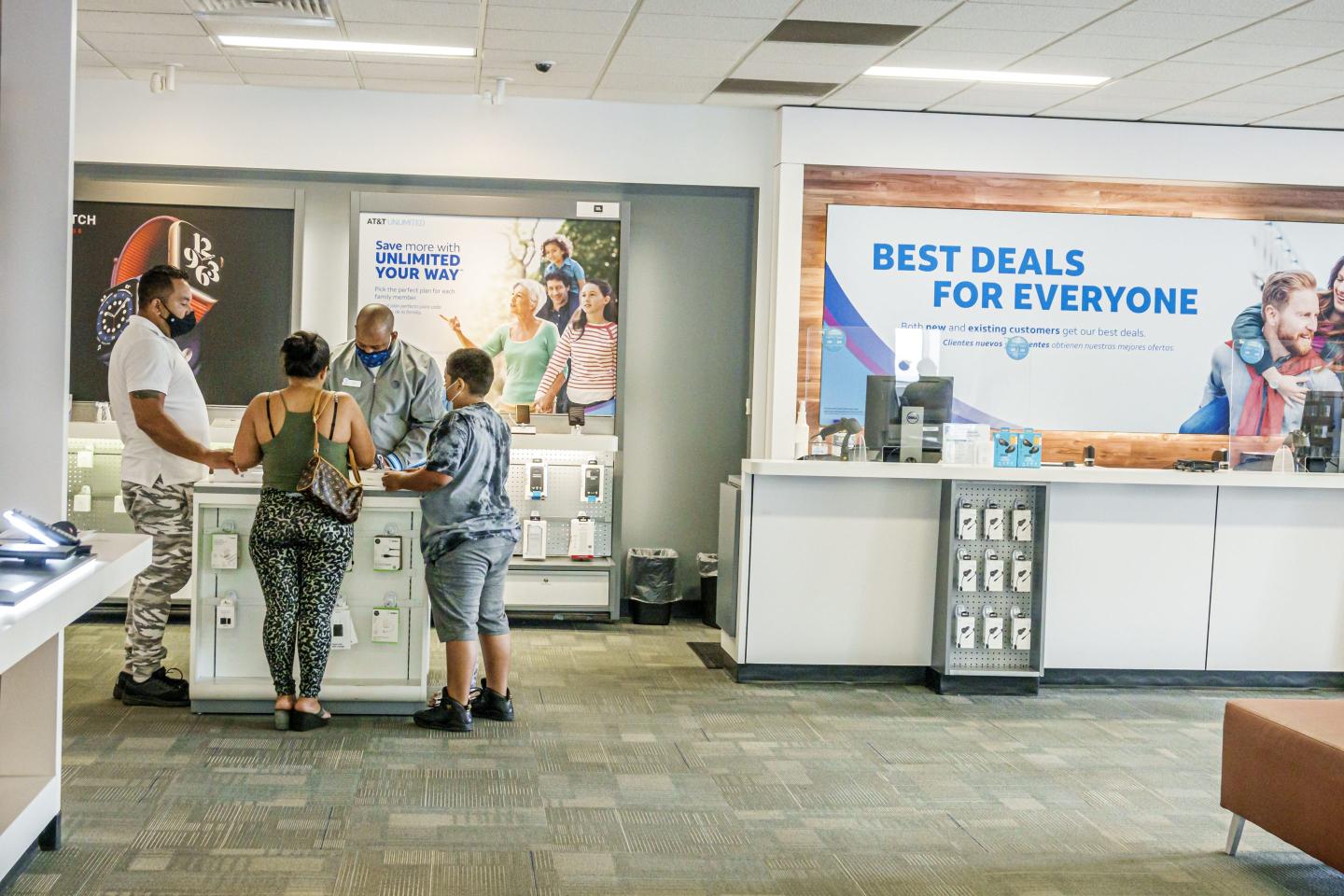 Customers meet with a salesperson inside an AT&T store in Miami.