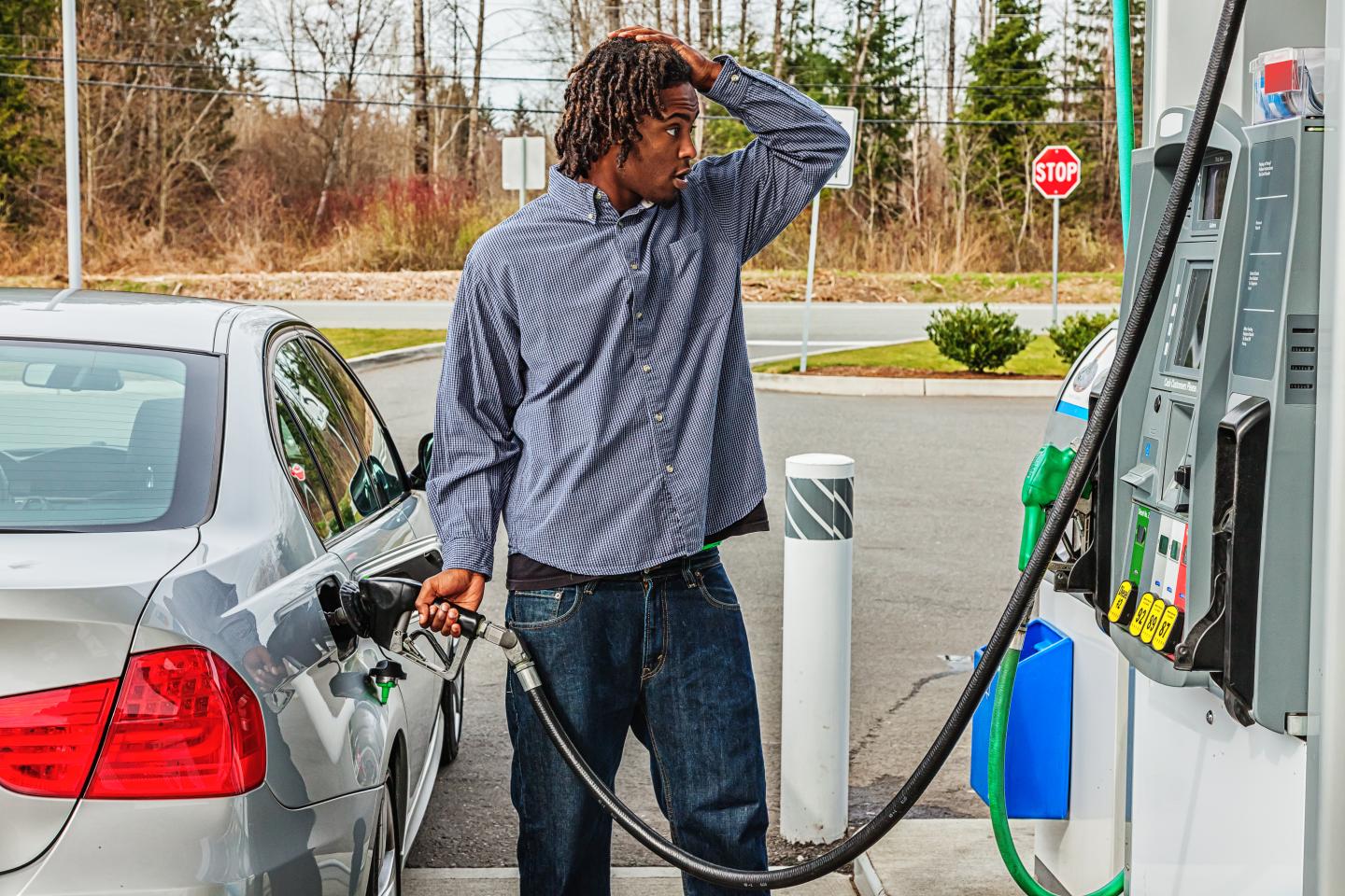 A young man at a gas station