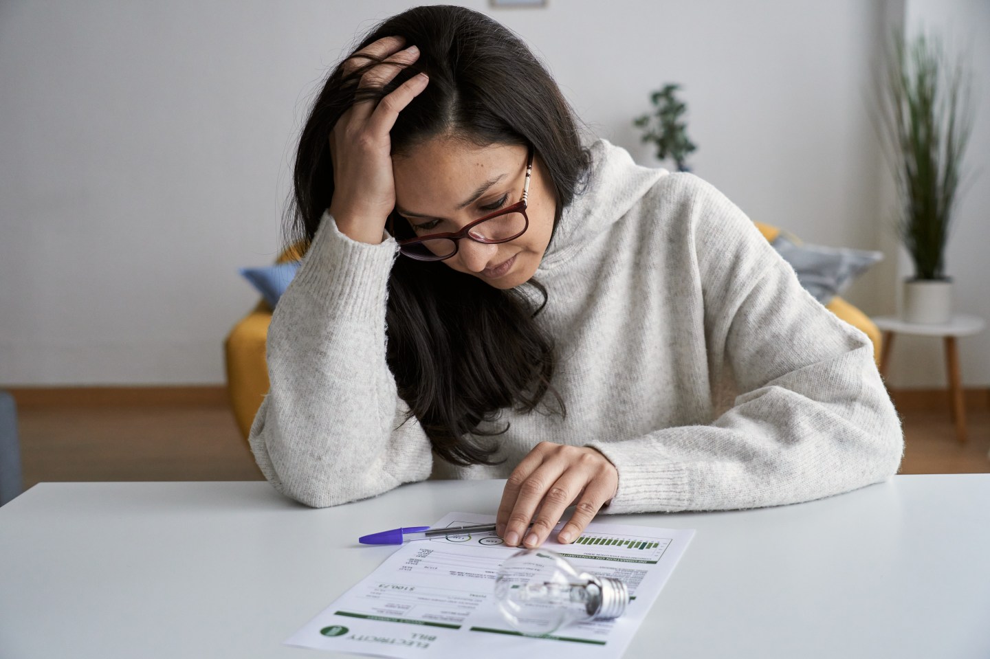 Woman looking at an electricity bill.