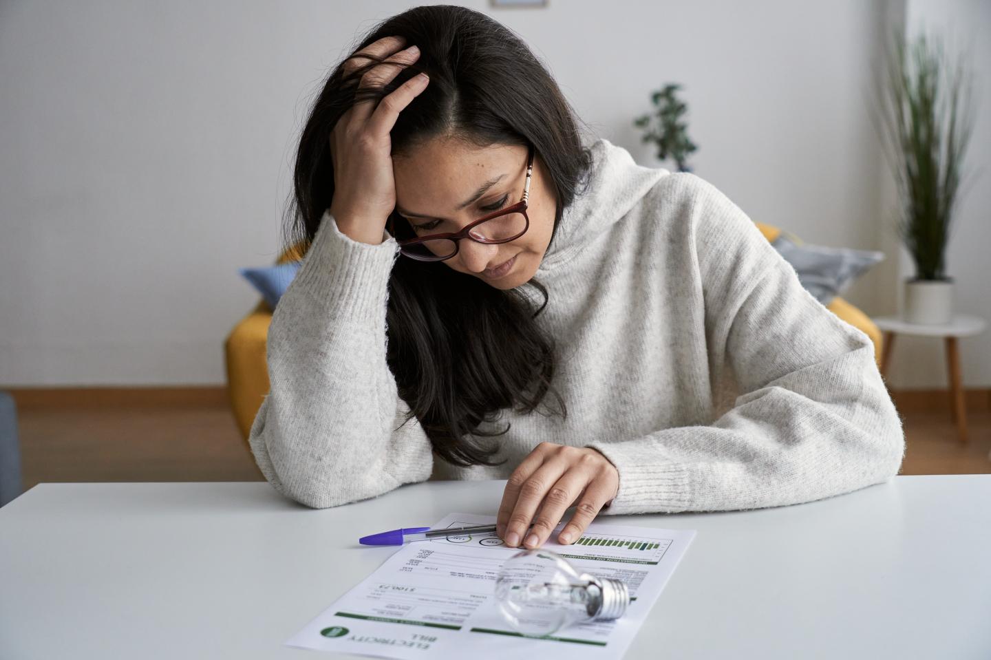 Woman looking at an electricity bill.