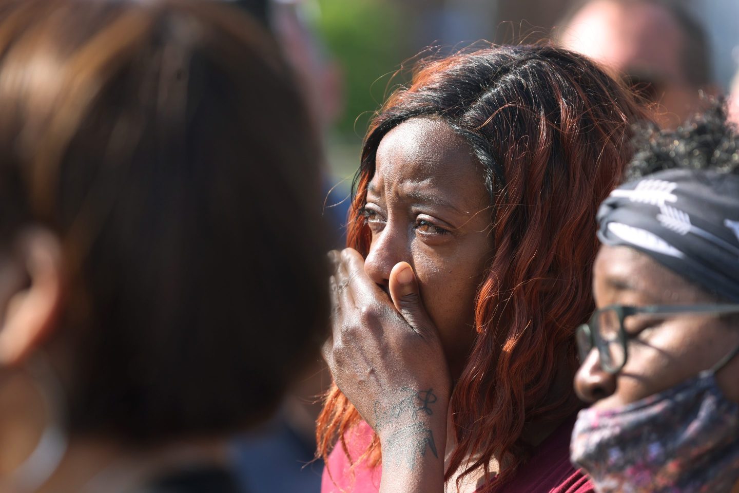 People gather outside of Tops market on May 15, 2022 in Buffalo, New York. Police said a white gunman opened fire at the store, killing 10 people and wounding three others in a racially motivated attack.