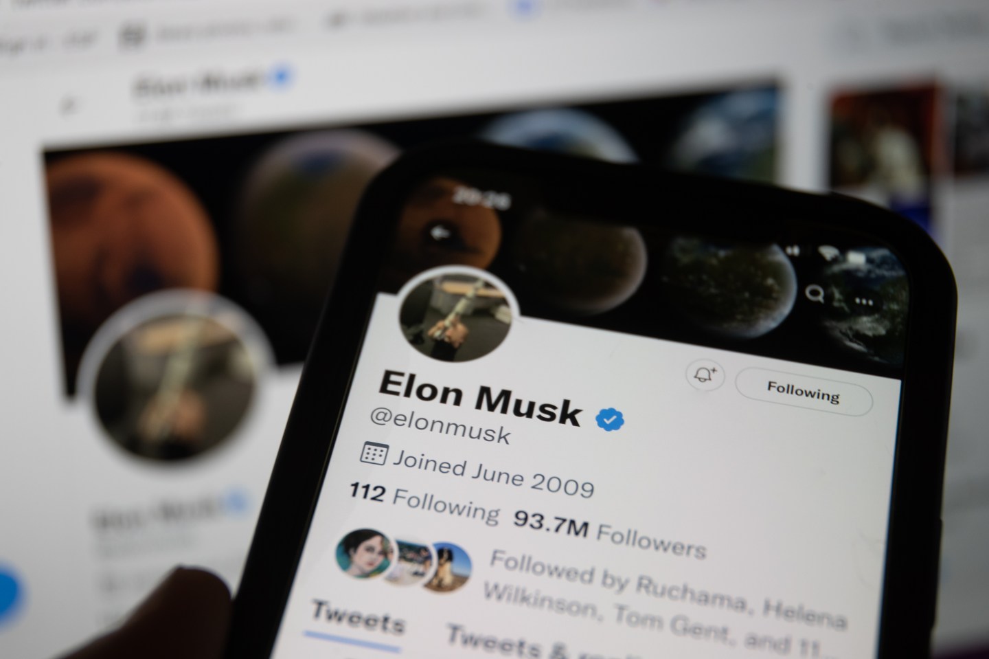 In this photo illustration a man looks at Elon Musk's Twitter account that is displayed on a smartphone screen on May 08, 2021 in Bristol, England. Billionaire entrepreneur Elon Musk has said his multi billion dollar deal to buy Twitter may not now happen due to a disagreement over the number of fake accounts on the social media platform