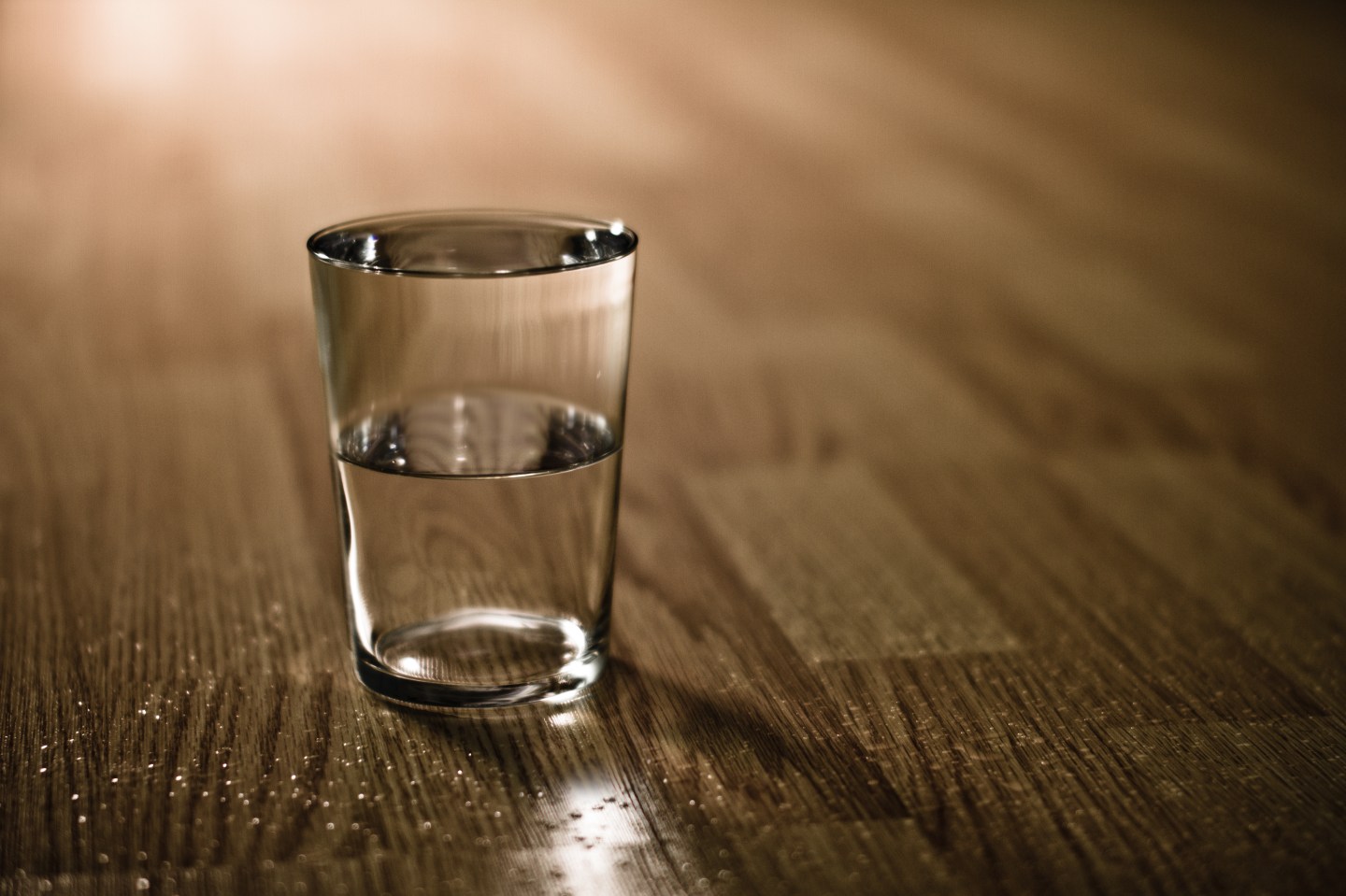 Half-filled glass of water on table