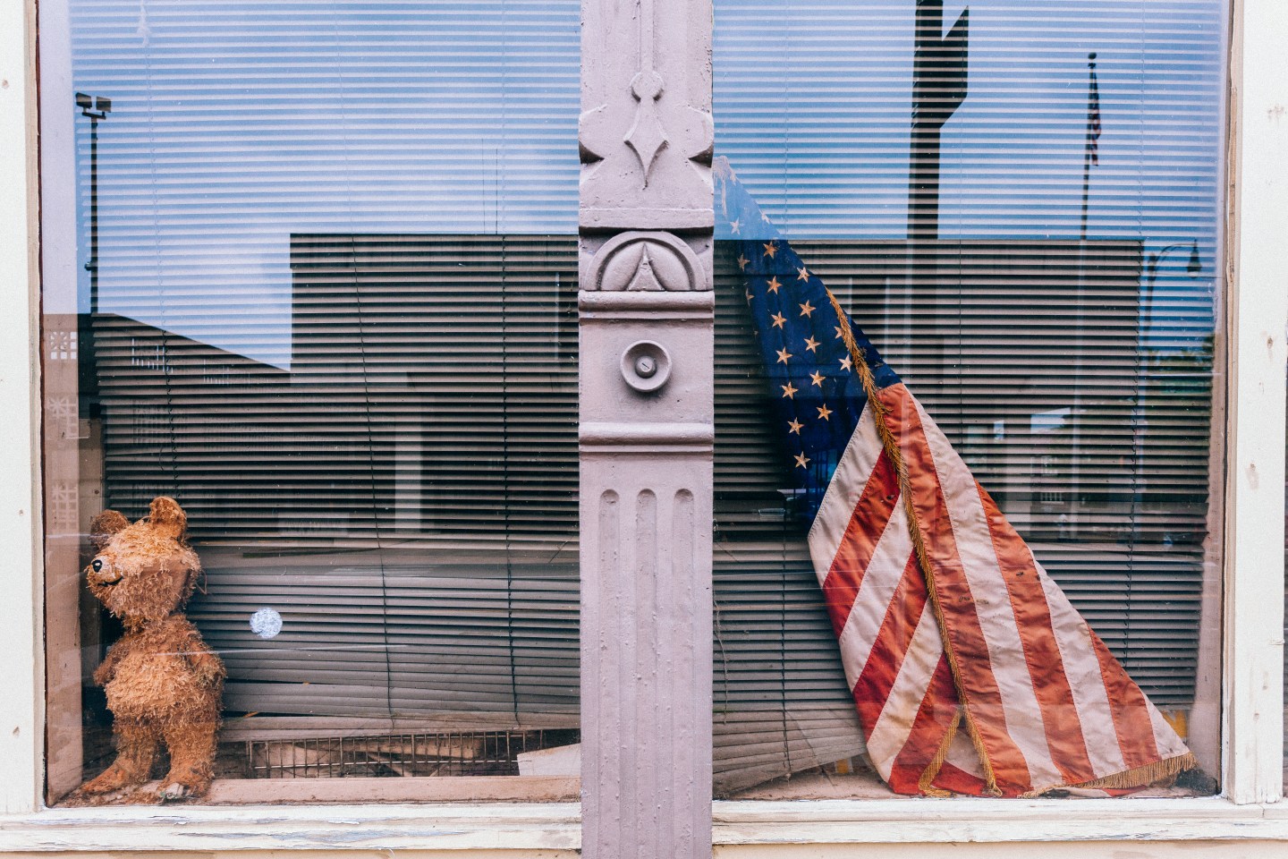 Store closed with American flag outside