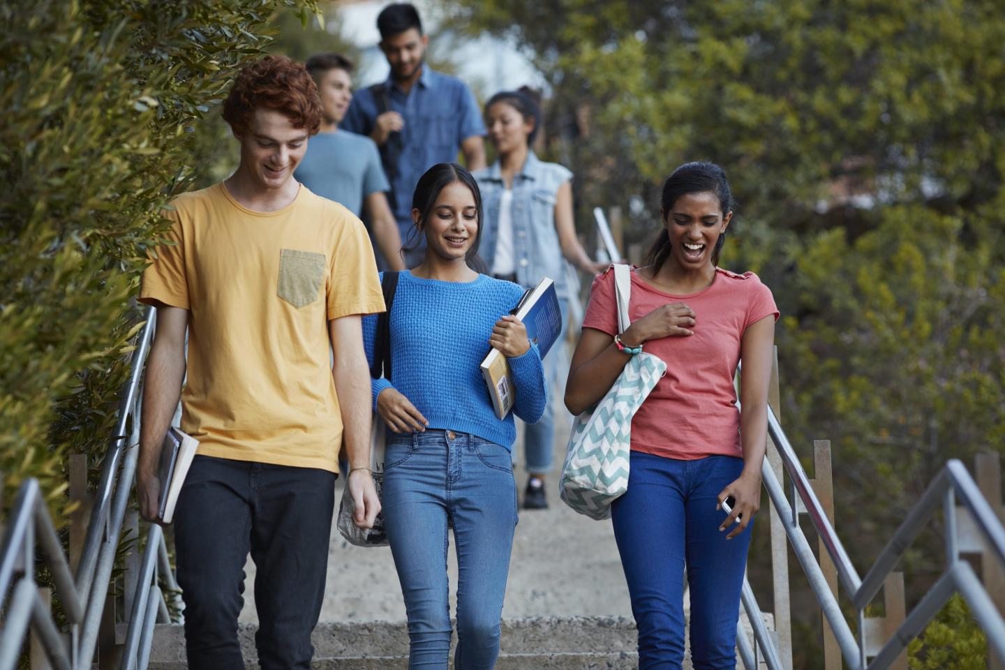 Friends walking down stairs after school