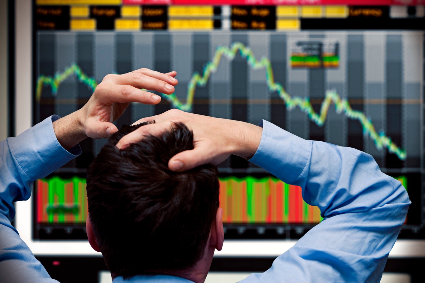 A trader watching stocks decline