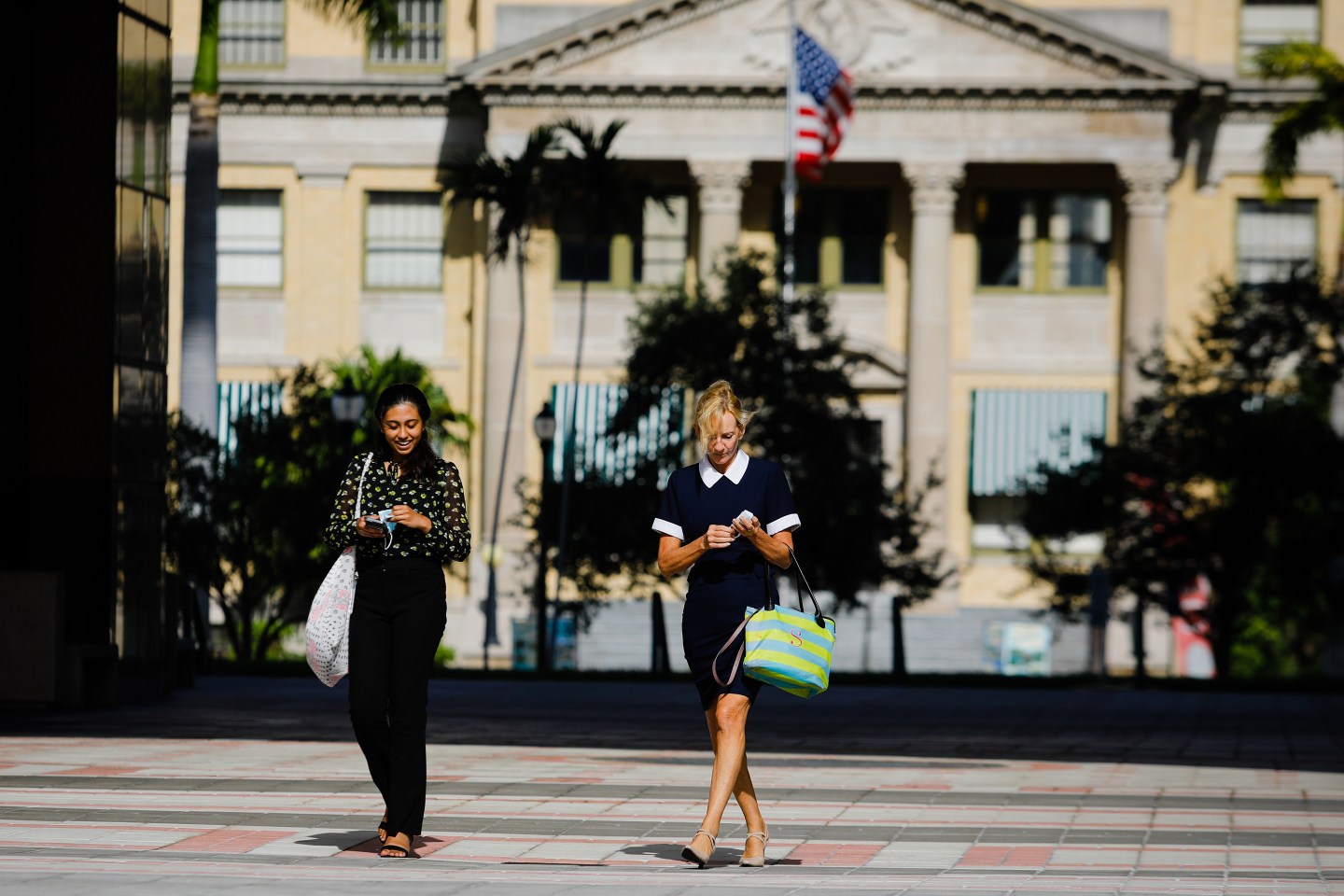 Women walk outside in West Palm Beach where Goldman Sachs plans a Manhattan-style makeove.