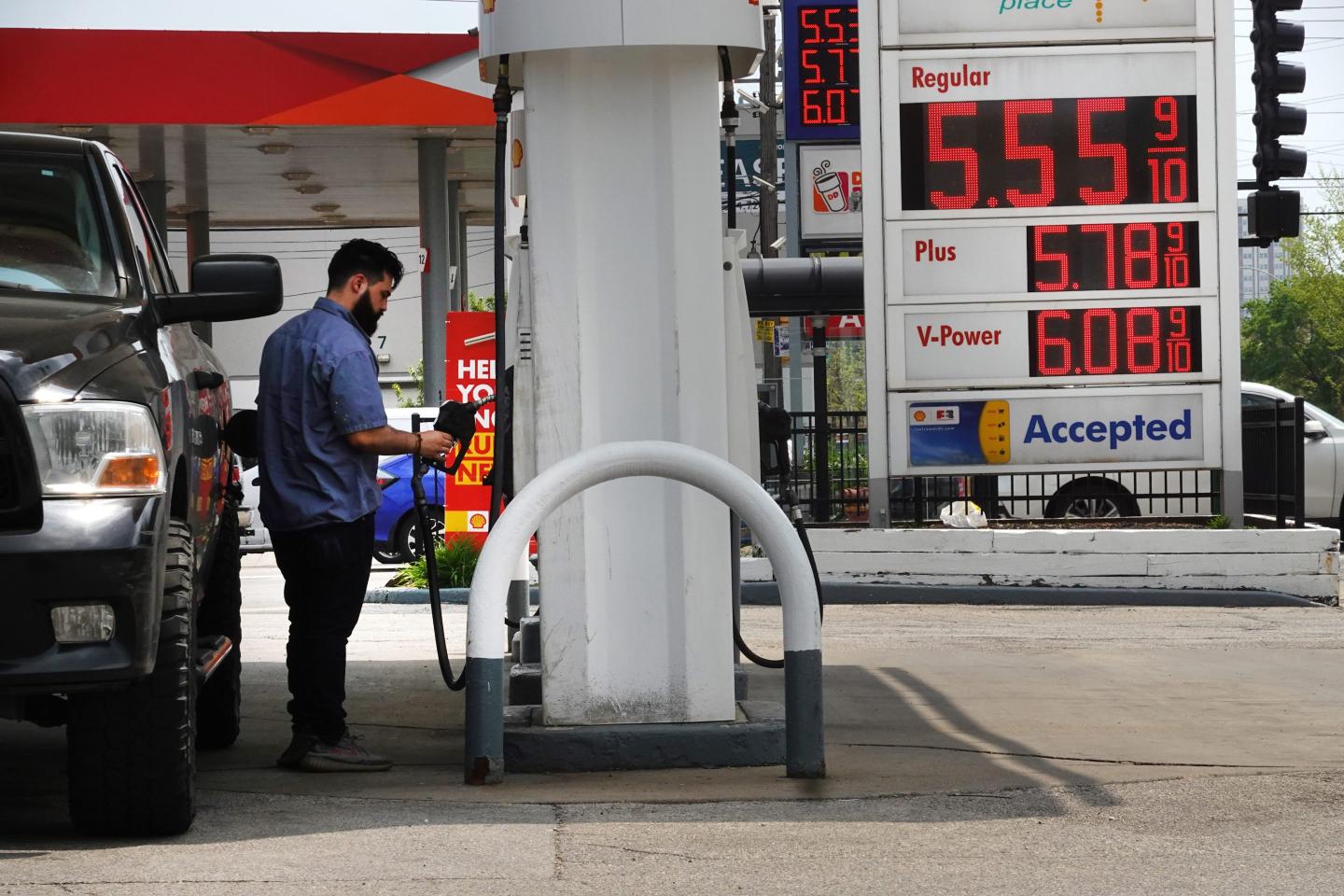 A man get gas for pick up truck.
