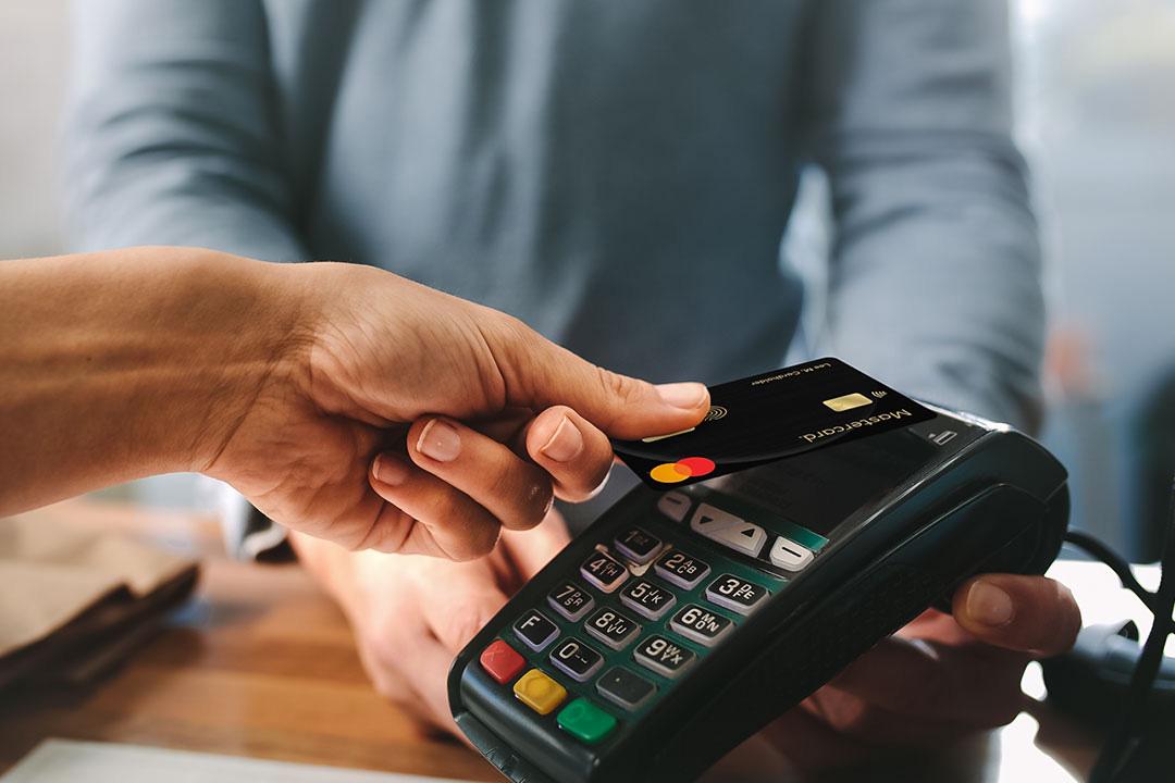 A person paying with MasterCard biometric card.