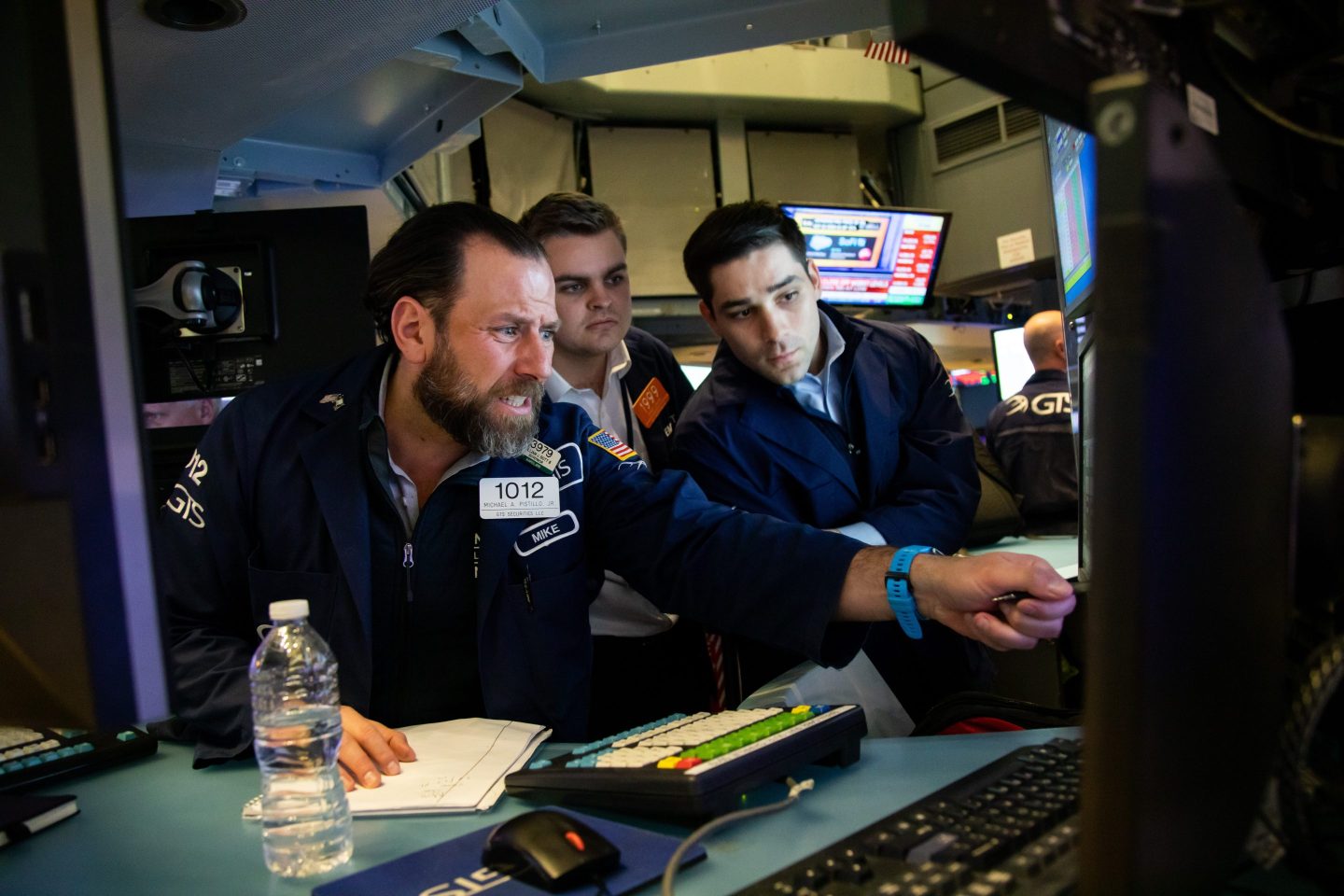 Three traders on the New York Stock Exchange.