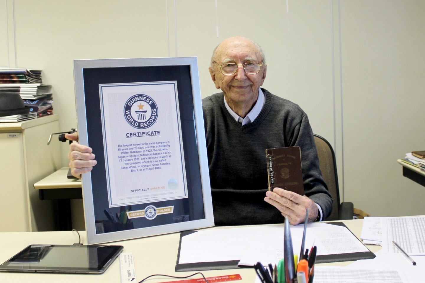 Orthmann is seen holding his certificate from Guinness World Records.