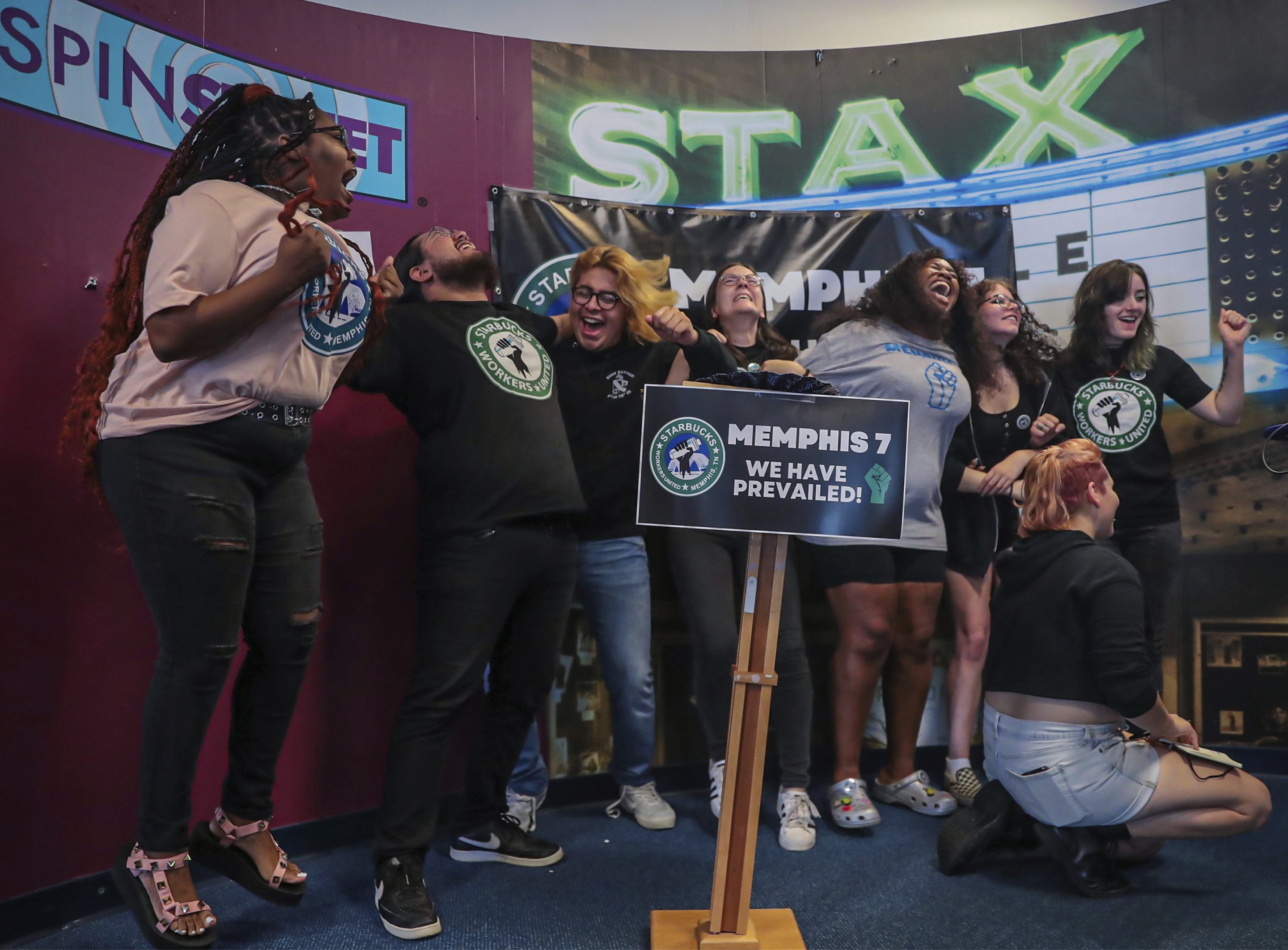 Members of the Memphis Seven, including Nabretta Hardin (from left), Beto Sanchez, Florentino Escobar, Lakota McGlawn, Nikki Taylor, Emma Worrell, Reaghan Hall and Kylie Throckmorton celebrate the successful vote to unionize their local Starbucks location in Memphis, Tenn. on June 7, 2022.
