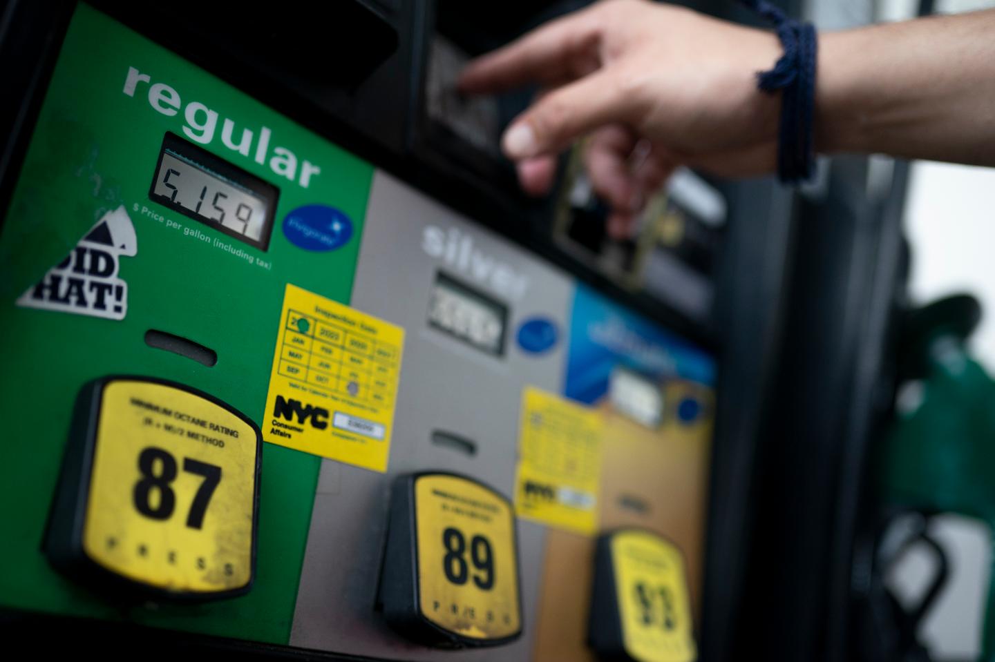Wallace Reid purchases fuel for the vehicle he drives to make a living using ride-share apps, Wednesday, June 22, in the Queens borough of New York.