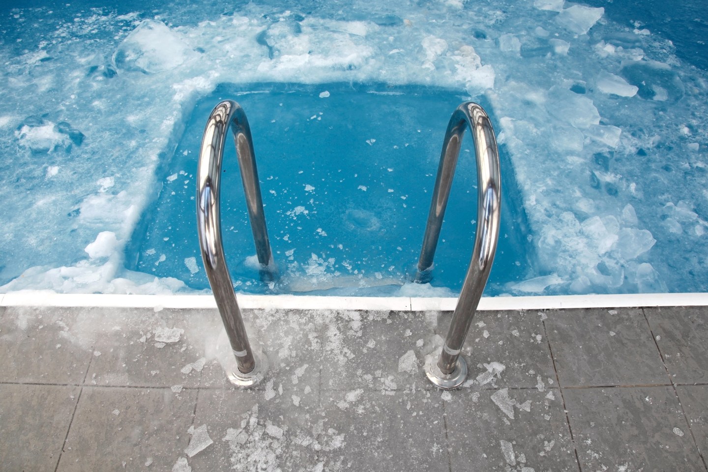 Steps in the frozen blue pool ice-hole.