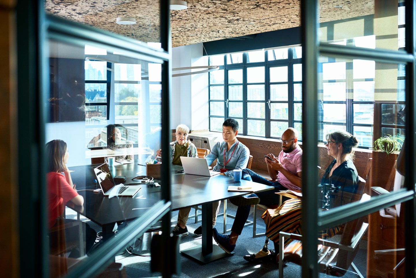 Multi racial team in equal opportunities company discussing and brainstorming, teamwork and cooperation.