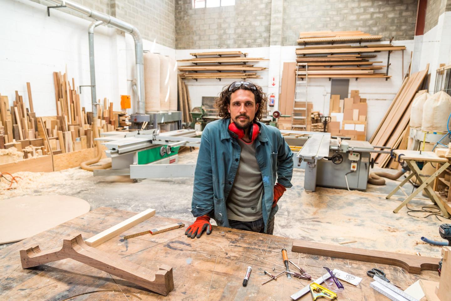 Portrait of young male worker in a furniture factory