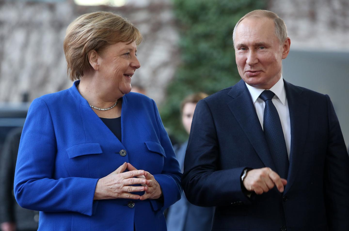 German Chancellor Angela Merkel (CDU, L) greets Russian President Vladimir Putin as he arrives for an international summit on securing peace in Libya at the German federal Chancellery on January 19, 2020 in Berlin, Germany.