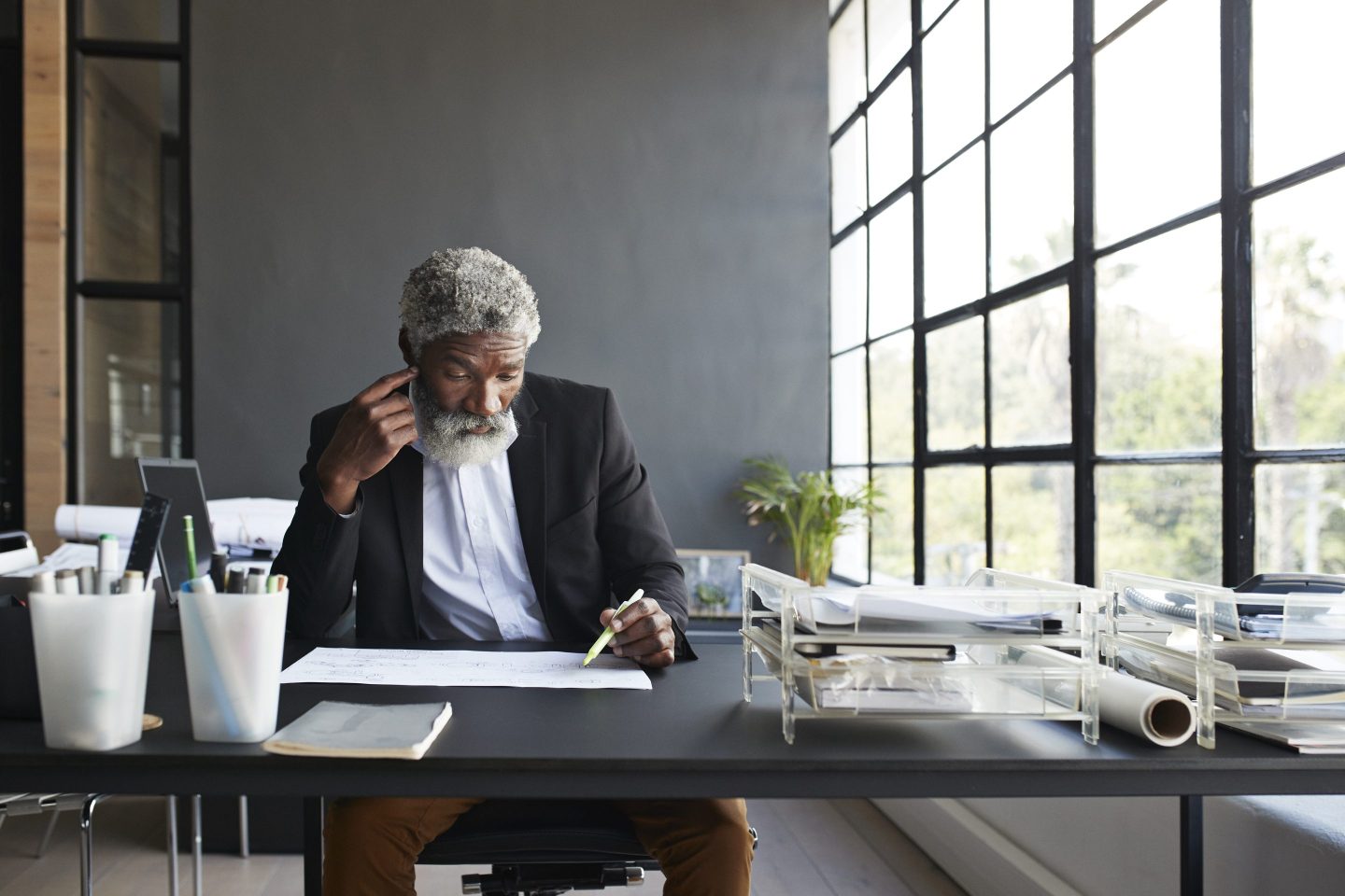 Businessman working on paper while sitting in a modern office
