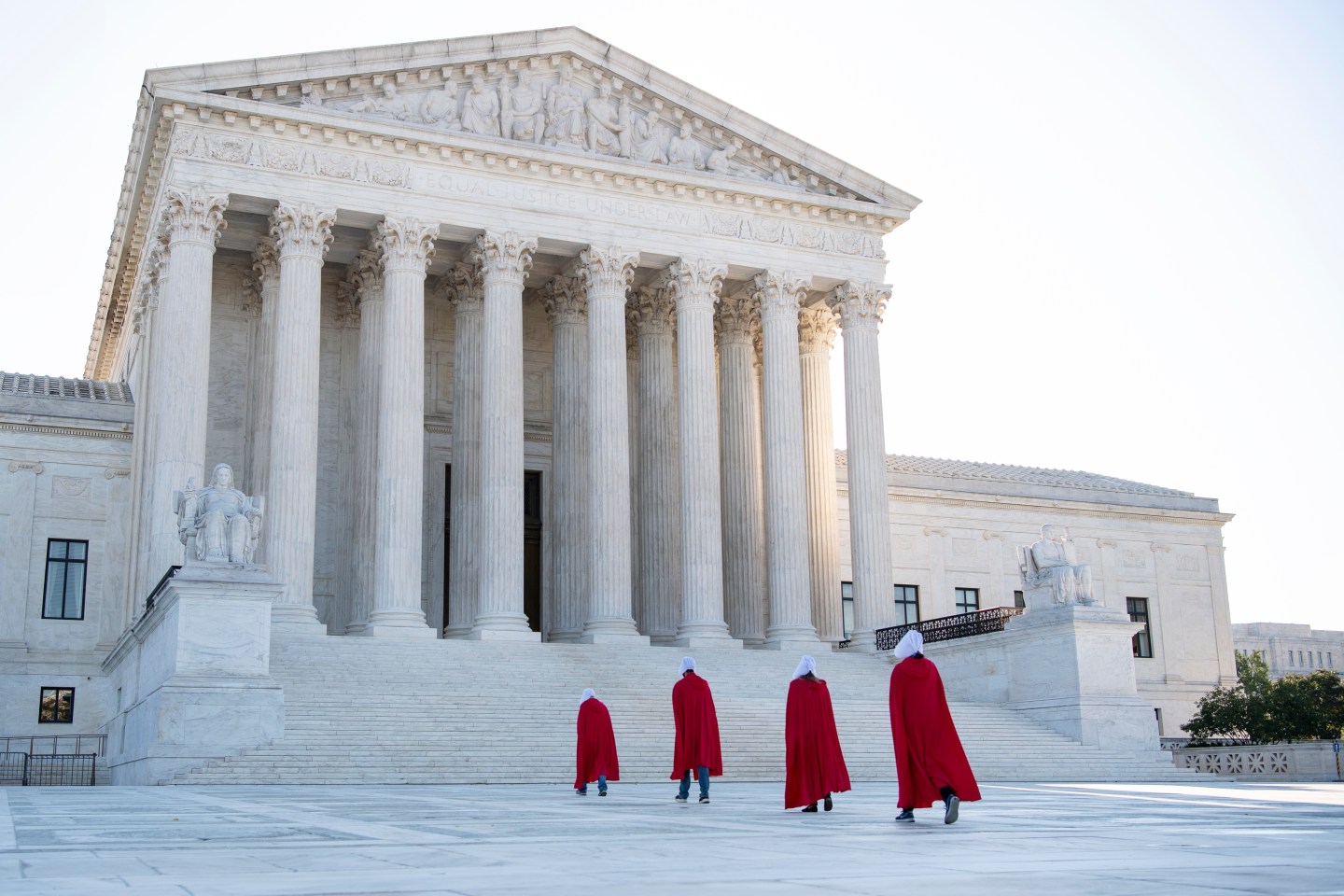 Demonstrators from the Center for Popular Democracy Action walk up the U.S. Supreme Court steps dressed in Handmaids Tale costumes to voice opposition to Judge Amy Coney Barrett's nomination to the court on Wednesday, Sept. 30, 2020.