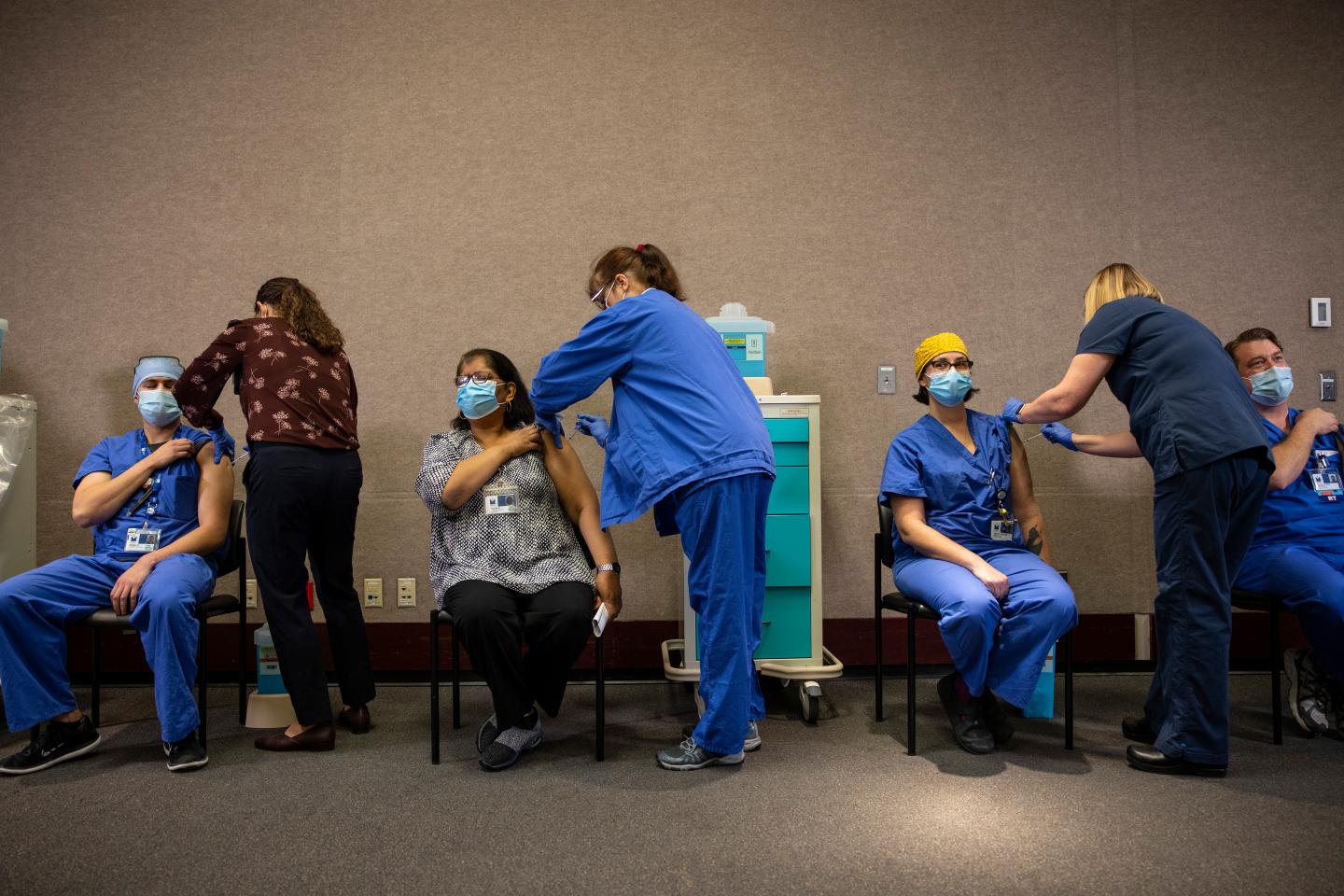 Healthcare workers get the Pfizer-BioNTech COVID-19
