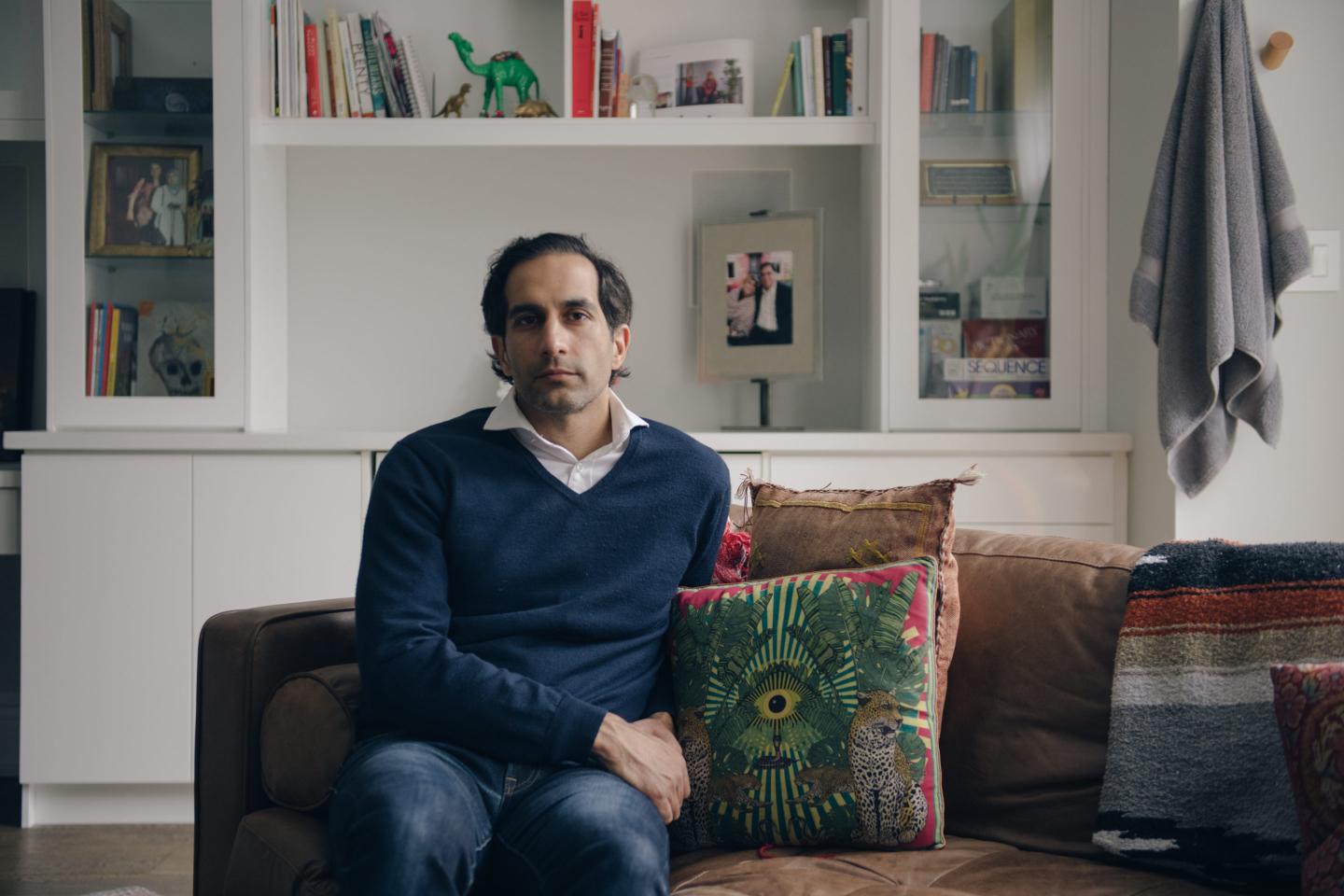 Tariq Fancy reclines on a sofa in a homely setting
