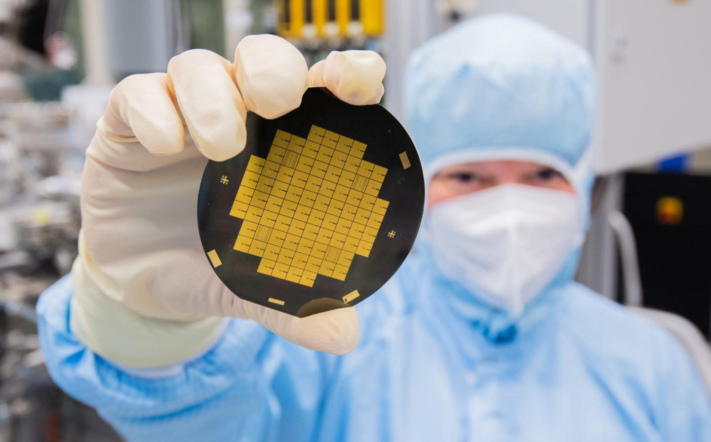 An engineer shows microchips for a quantum processor.