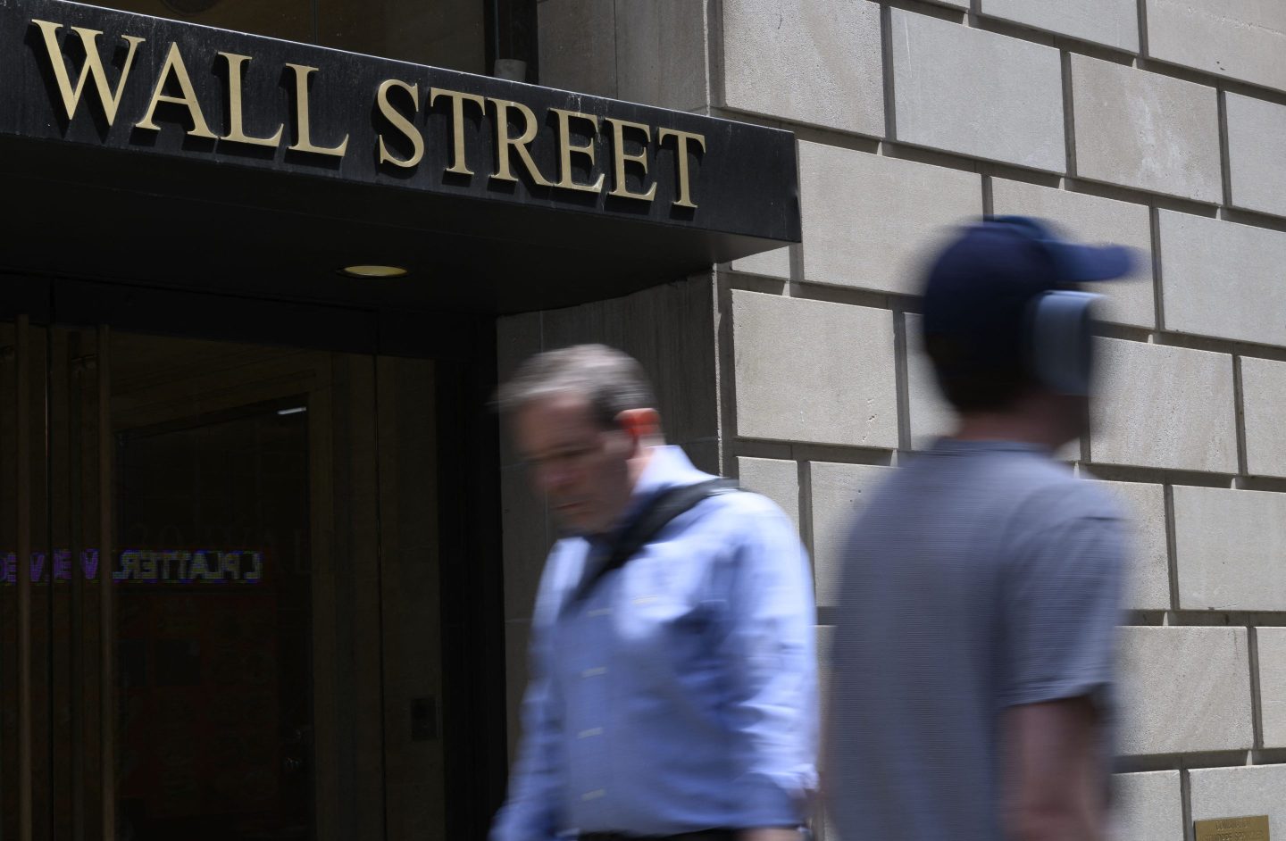 Picture of people walking on Wall Street in lower Manhattan.